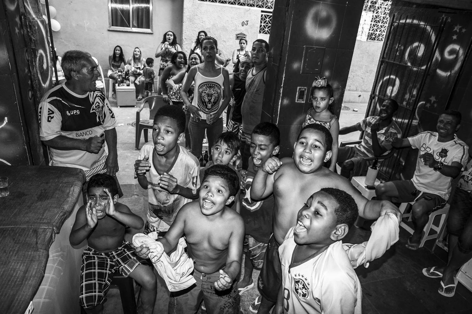  Residents of Vila Cruzeiro's favela are gathered in a bar looking Brazil winning on penalties over Chile.&nbsp; 