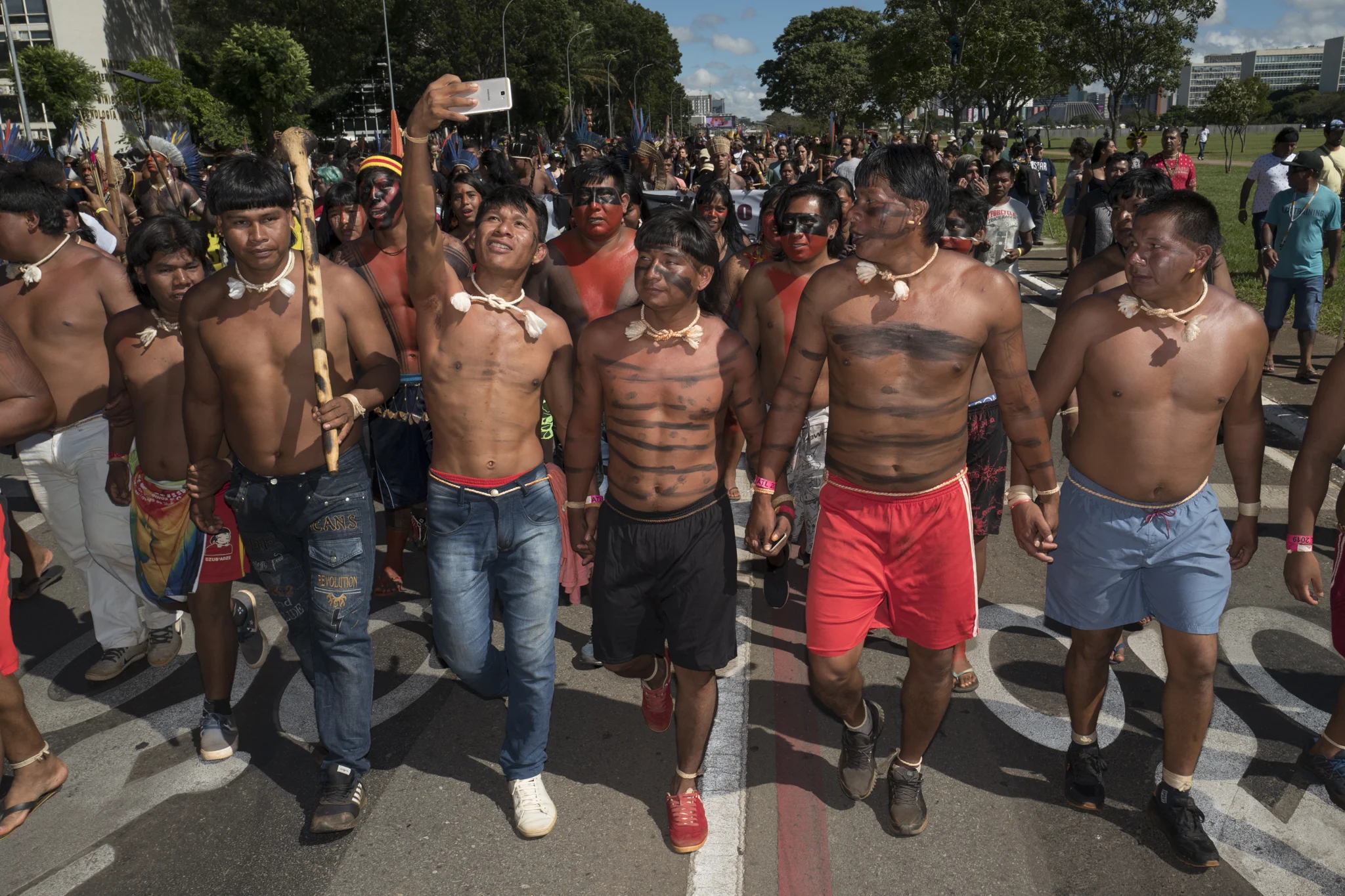  A young native of the Xavantes people takes a selfie with his friends as they protest the rights of Brazilian indigenous peoples. 