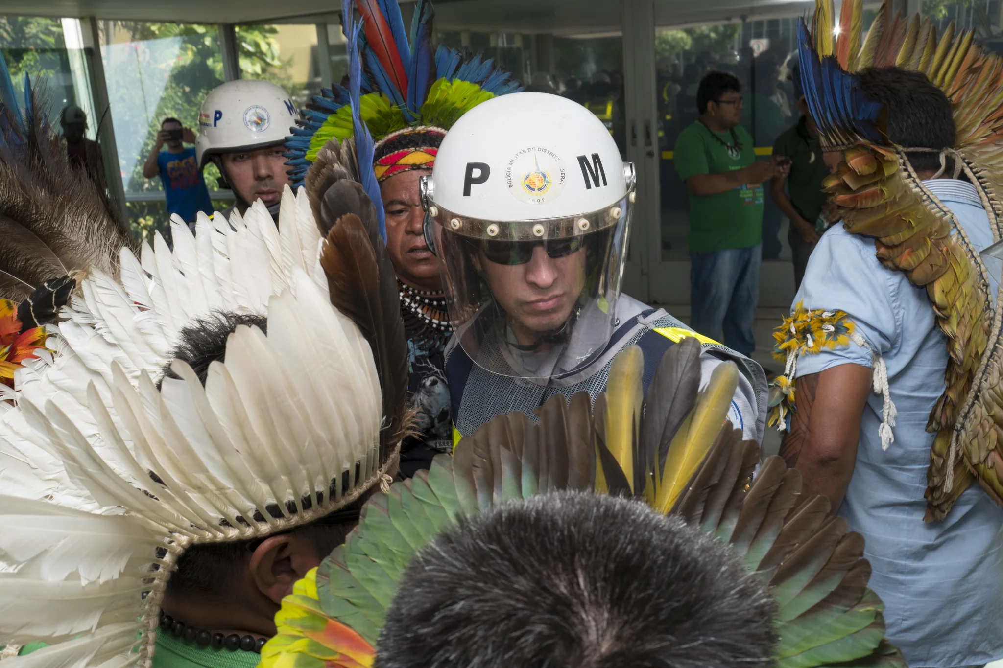  A military policeman blocks the access of Brazilian natives to the entrance to the health ministry of Brasilia 