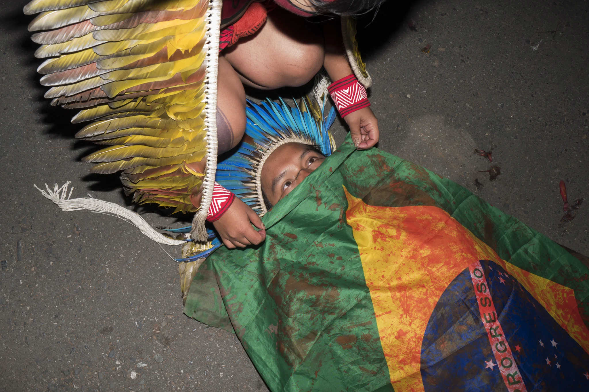  A young native simulates a murder to protest the murder of indigenous people in Brazil 