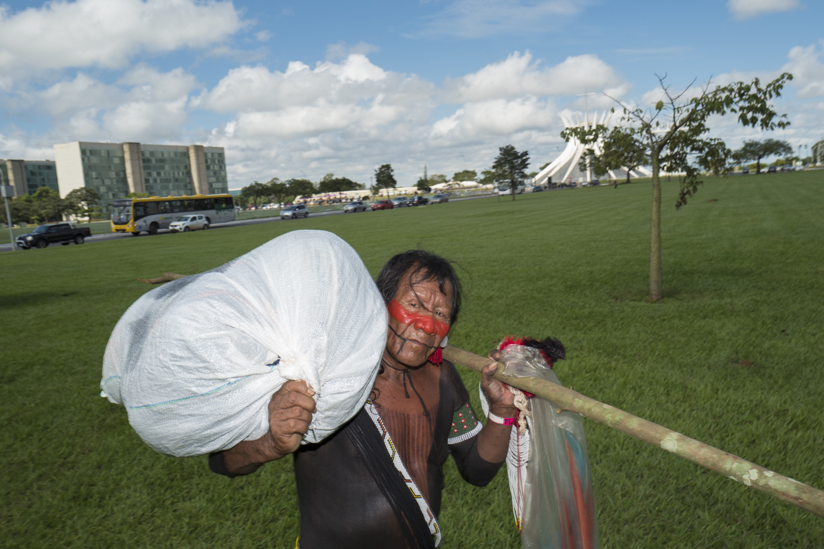  An old Kaiapo man is seen leaving with his belongings  after leaving the camp near the presidential buildings of brasilia after the military intimidation of the use of force against the Free Land camp in Brasilia. 