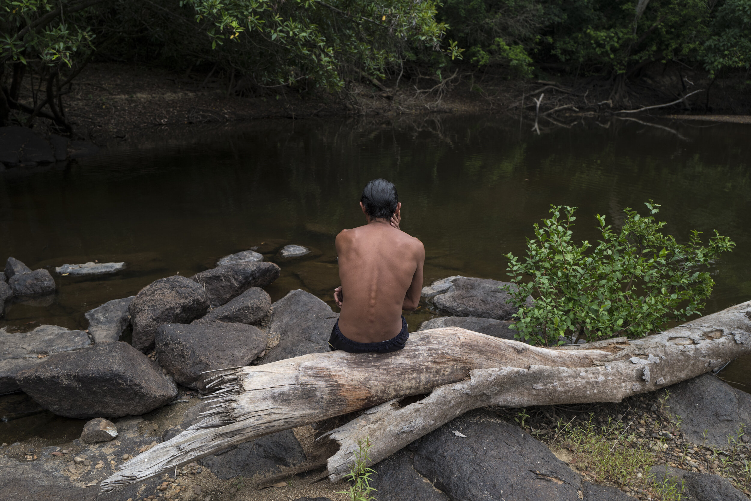  Juripe, 40, sits after diving into its waters of the Jamarí River, within the Uru Eu Wau Wau Indigenous Territory, Rondonia.  