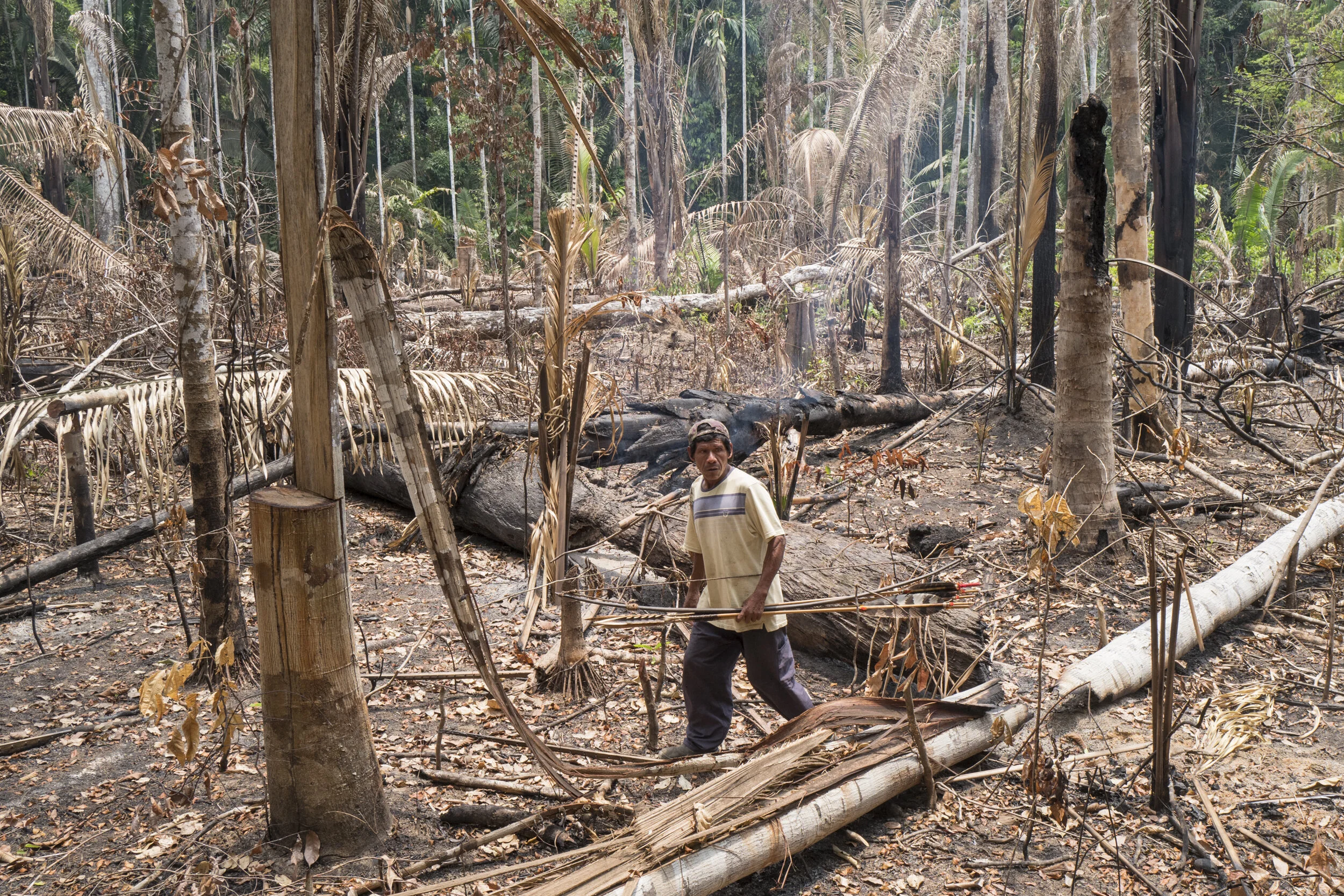  An indigenous man walks in a recently invaded and burned rainforest located inside the indigenous reserve Uru Eu Wau Wau, Rondonia.Contacted in 1981, the indigenous Uru Eu Wau Wau share with uncontacted tribes a vast territory of native rainforest, 