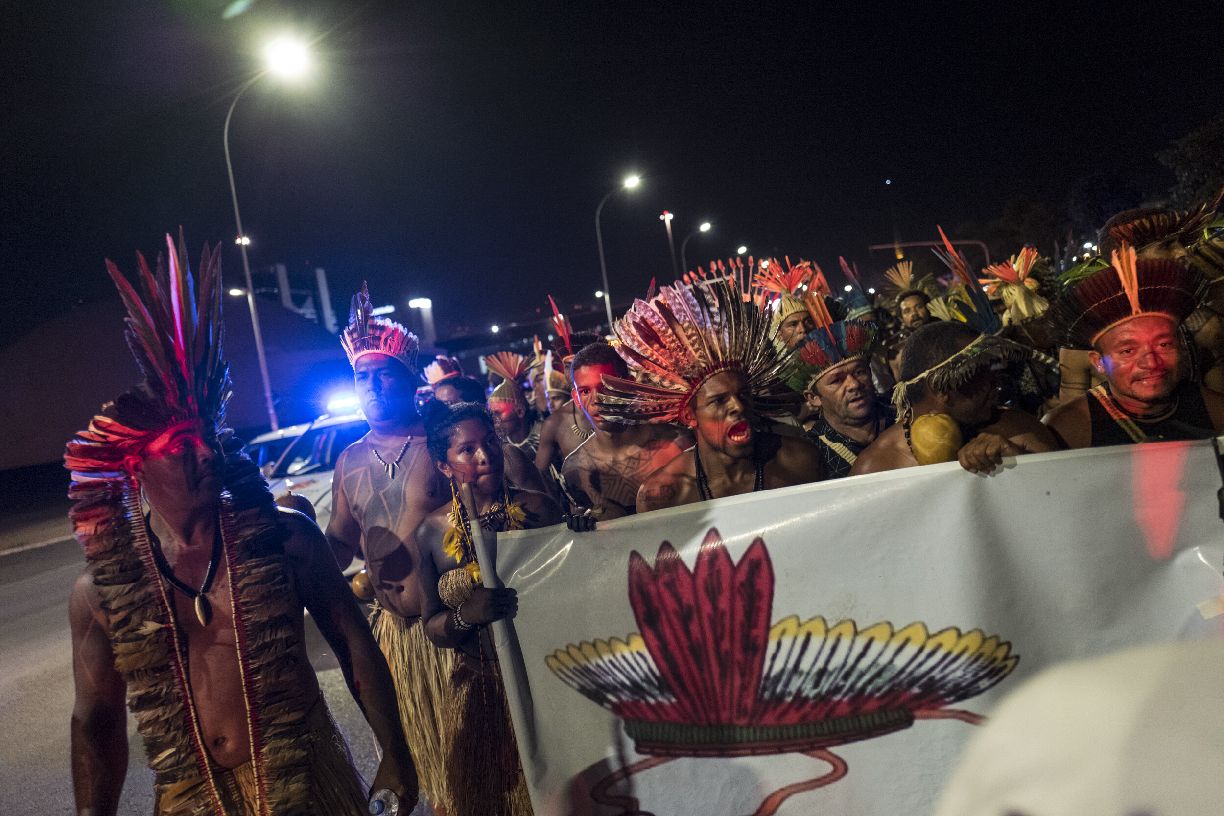  Indigenous people walk the path that leads to the Brazilian government building protesting for the respect of indigenous rights, in Brasilia. 