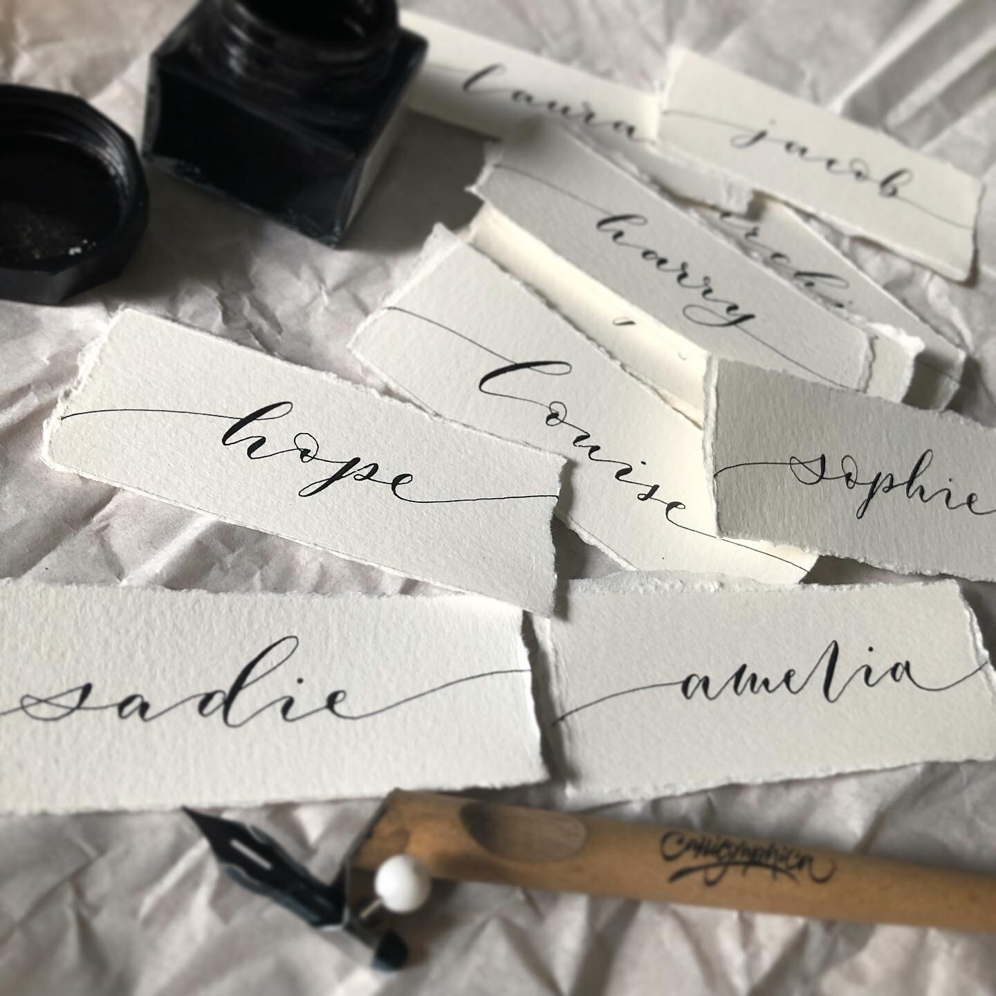 Hand written calligraphy place name cards, in jet black ink on heavy watercolour paper with hand torn edges 🤍🖤
-
#calligraphy #moderncalligraphy #blackink #ink #penandink #decklededges #wedding #stationery #weddingstationery #handmade