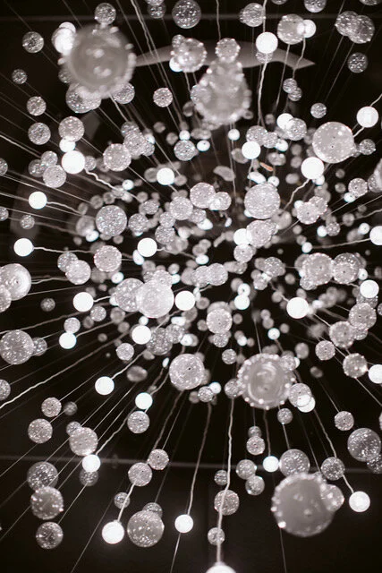 THE SALON CHANDELIER  is uniquely made up of hundreds of lights and orbs that dance in the breeze.
