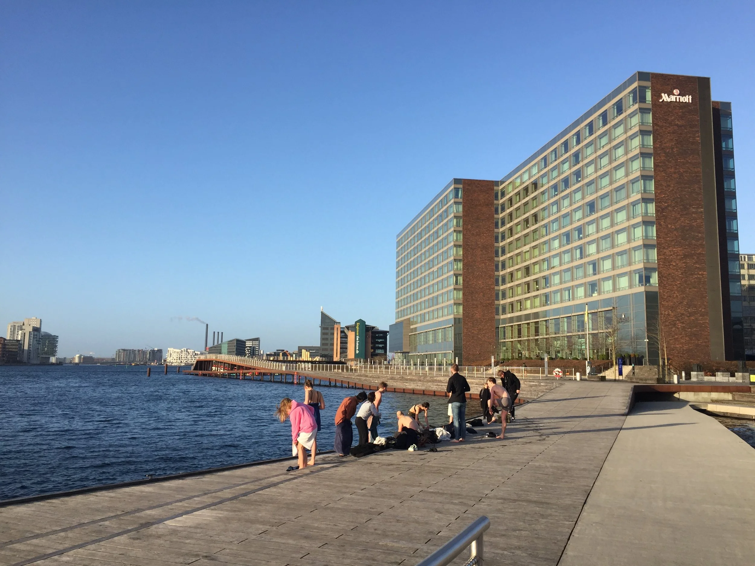 Nordic Plunge? a coed group changing from street clothes to bathing suits, climbing down the ladder for a dip in the river. Never releasing from the ladder, back up, and changing. Invigorated?!