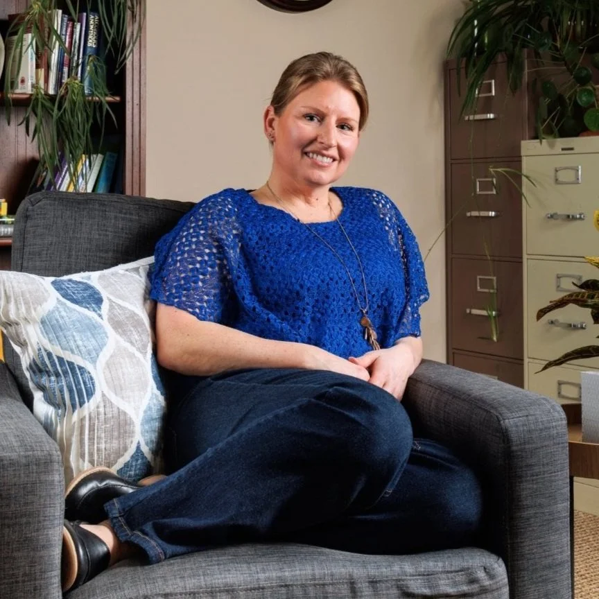 Rachel Baker, Spokane therapist, sitting in an office chair.