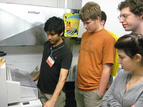 I show the class how to use the paper cutter in the lab.