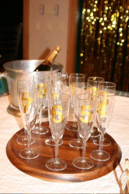 I copied this idea from an old issue of Martha Stewart Magazine—you take silver or gold number stickers and individually number your champagne glasses, like a New Year’s countdown. It not only looks cute, but helps you keep track of your glass all night (very helpful on New Years!)!! Now if only I could locate numbers 3 and 6… they’ve gone missing since that night….