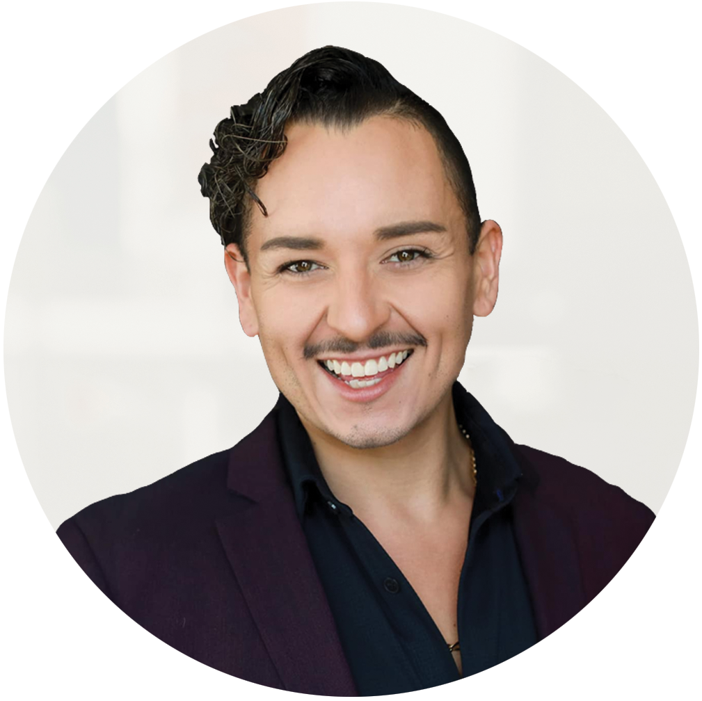 Cisco Hernandez, smiling at the camera, wearing a dark suit.
