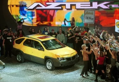 2001 Pontiac Aztek - Mind the the gap between concept and execution: It's a wide one. The aztek was prescient in its anticipation of the crossover craze. But, after GM's bureaucrats had worked it over with their cudgels of consumer research and brass knuckles of corporate mandates, what could have been the decade's greatest automotive success, became it cruelest joke. (Pontiac ad circa 2001)