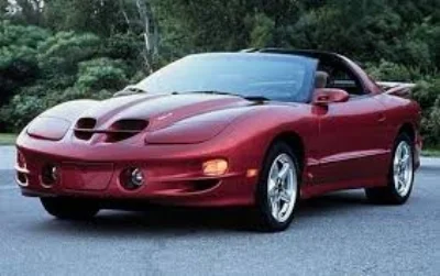 It's hard to know what to say about the 4th generation Firebird. The Three previous birds from 1967, 1970 and 1982, each in their day looked brutally elegant and primed for action. This 2002 Pontiac Formula Firebird Packs big power, that's for sure. though it appears to be overwhelmed by the prodigious ladling on of Lard (www.edmonds.com)