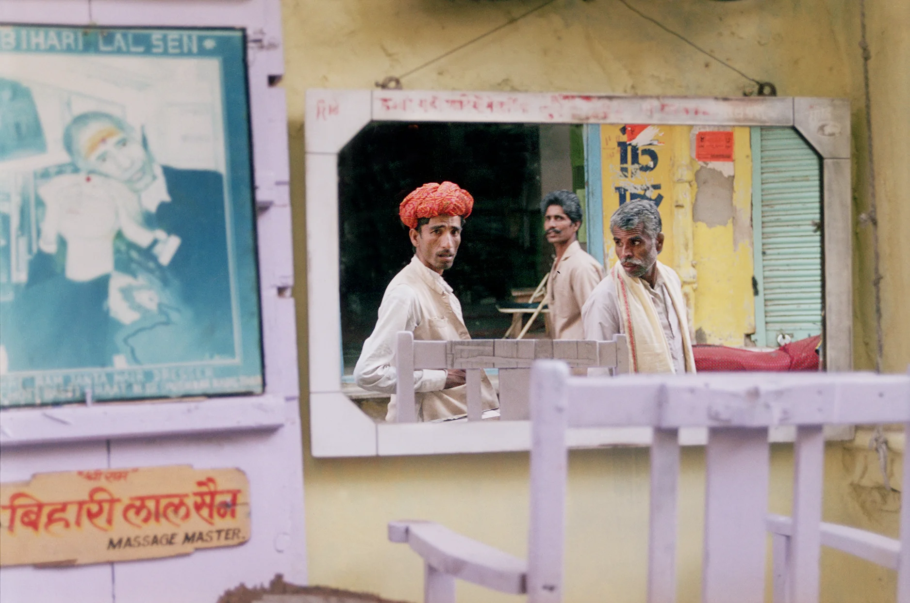 Reflection of a man walking down the street in Pushkar, India. By Jessica Scranton