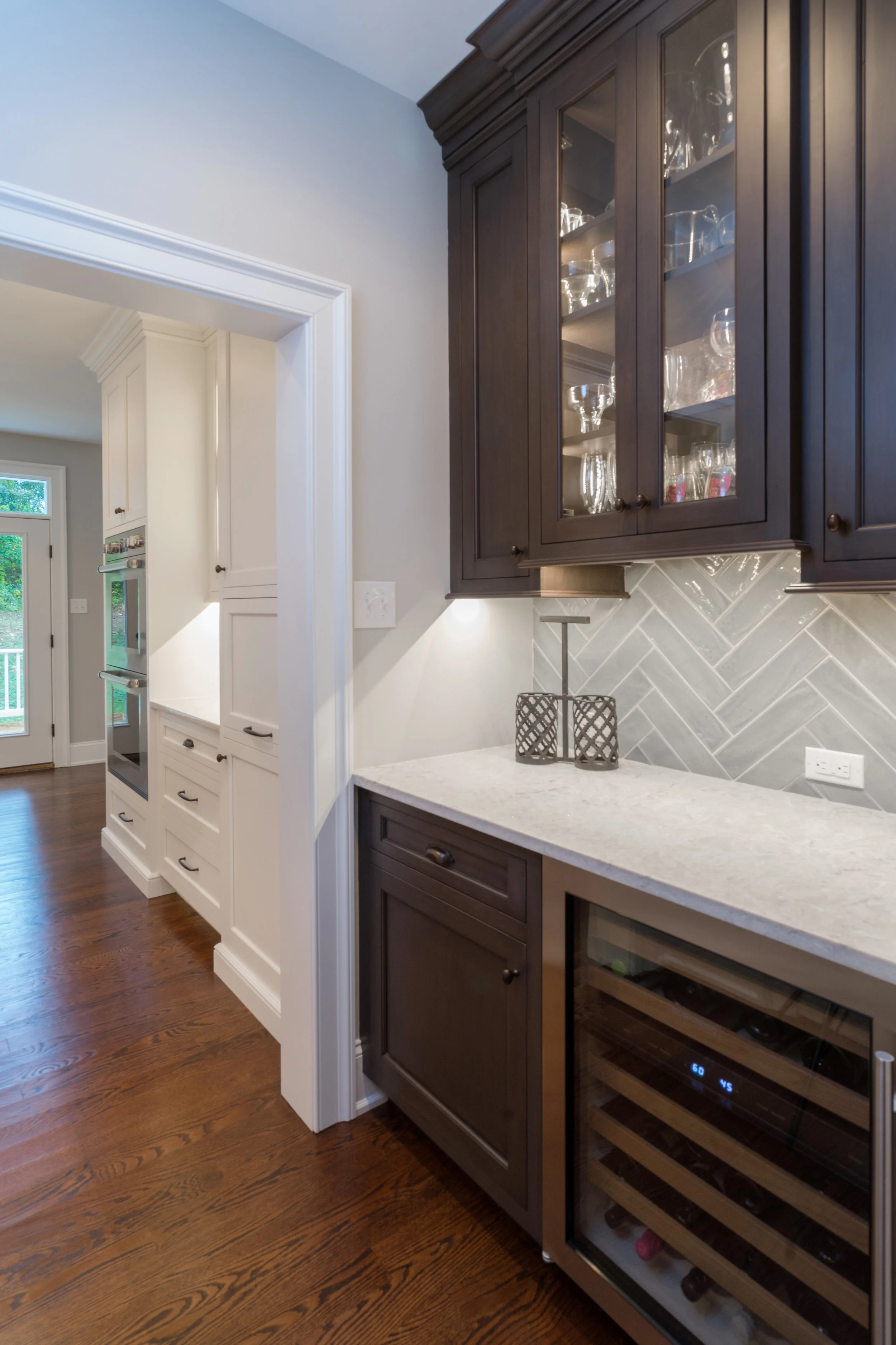 This view of the butlers pantry next to the kitchen mixes well being the same color as the island.
