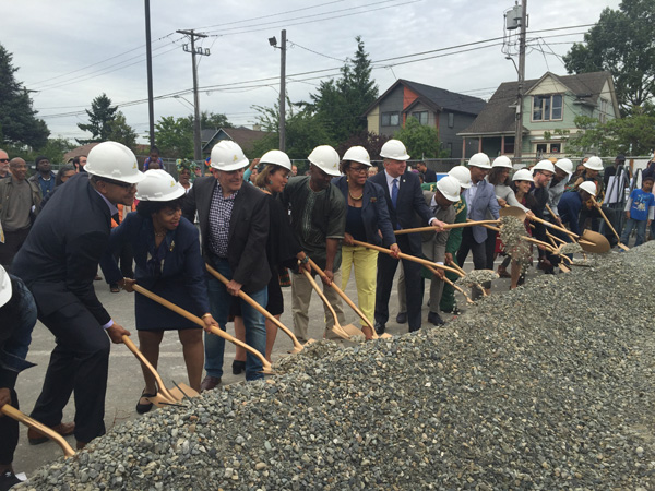 Photo by Ester Kim: The ceremonial dirt gets moved during the groundbreaking for Capitol Hill Housing's Liberty Bank Building.