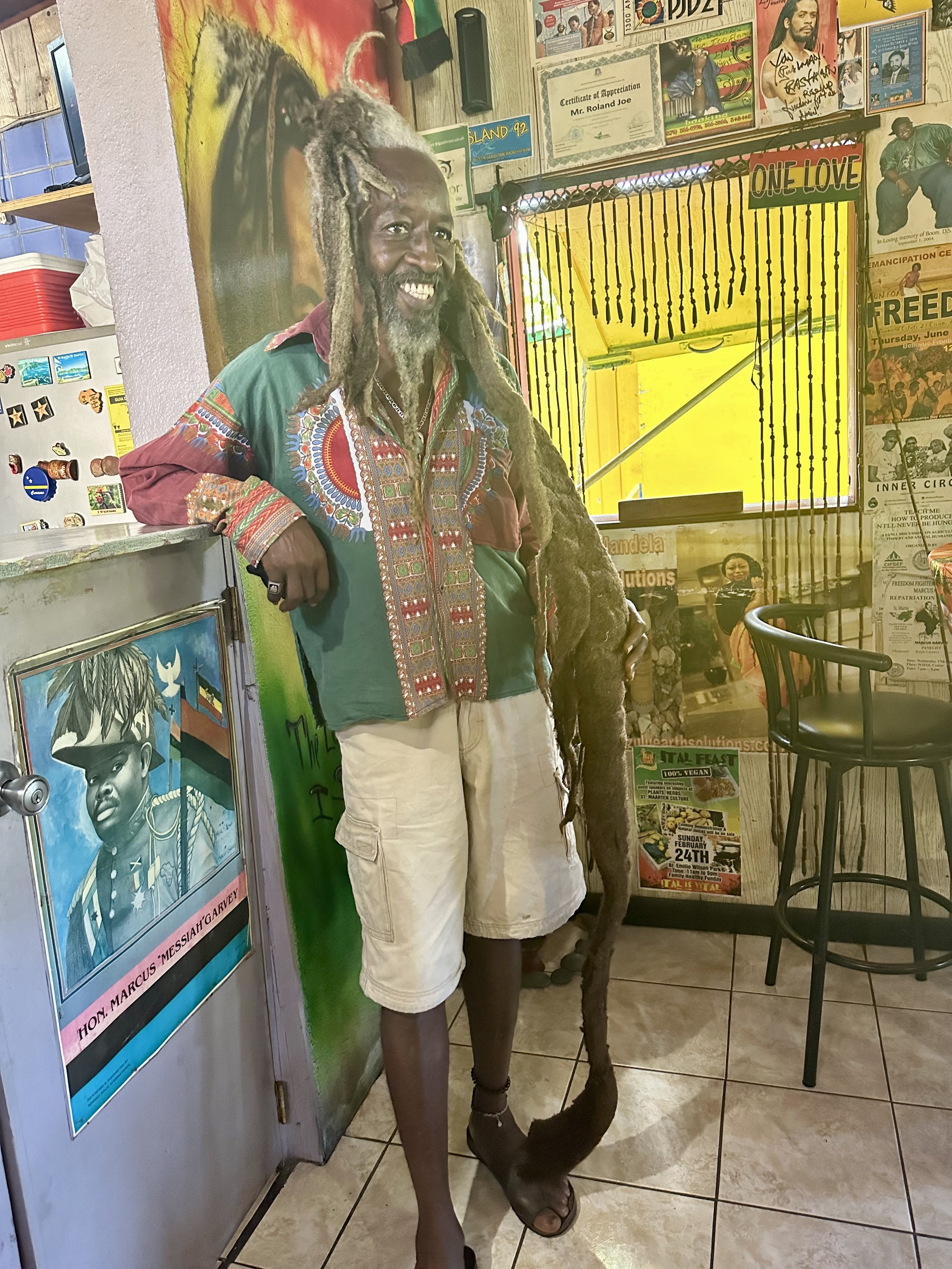 Ras Buschman presides over his restaurant in Sint Maarten.jpeg