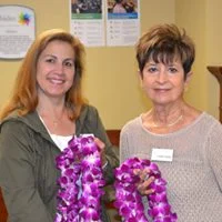 Patti Baker and Karen Swan presenting leis to Hillsides Graduates