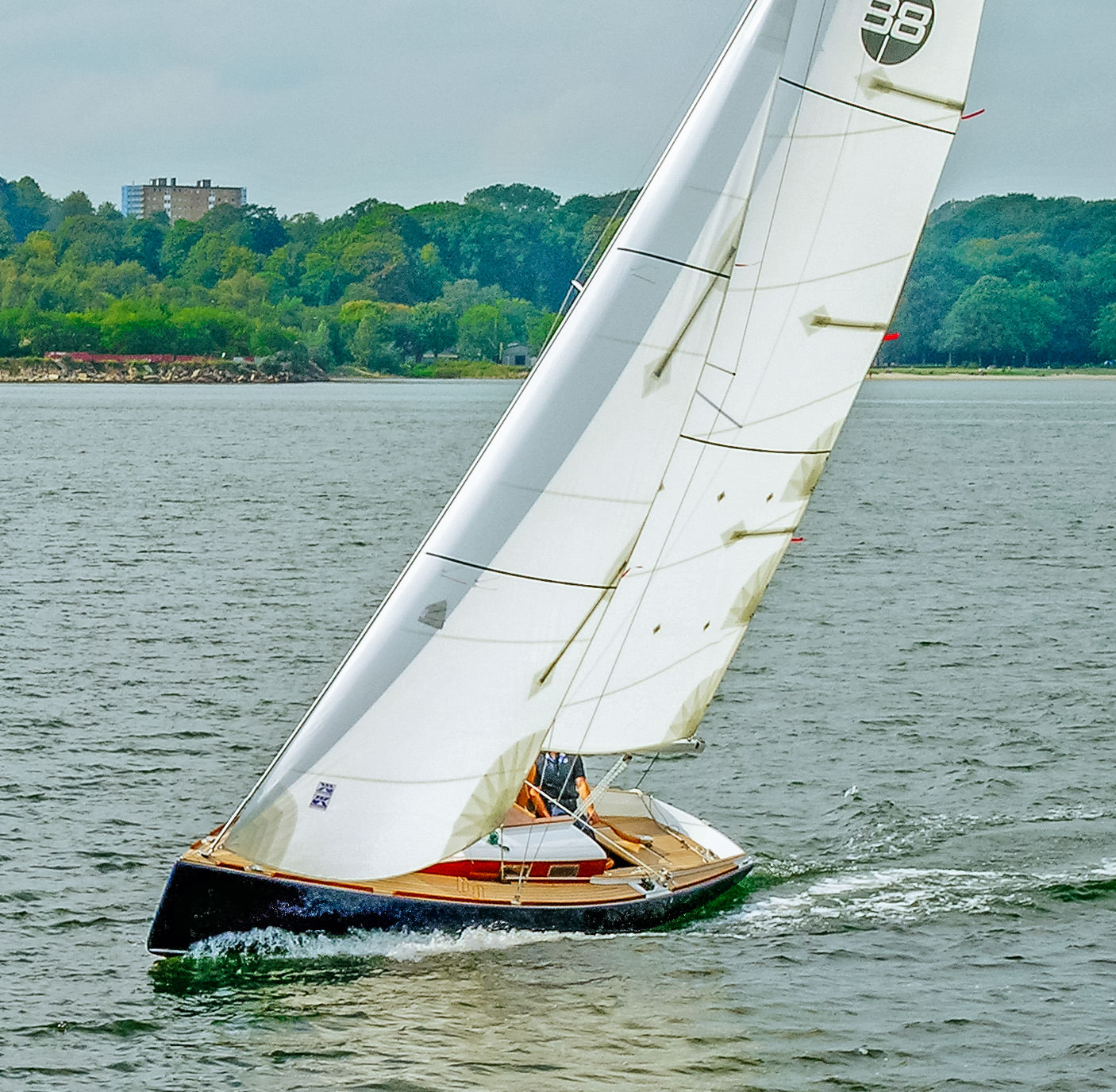 Modern classic daysailer with Dacron cruising mainsail and roller-furling jib with vertical battens.