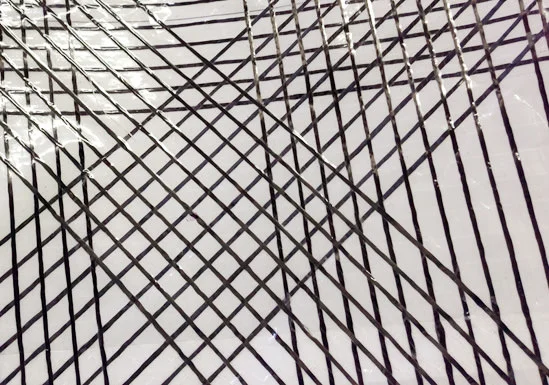 Close-up of carbon X-Drive tapes on a polyester laminate.
