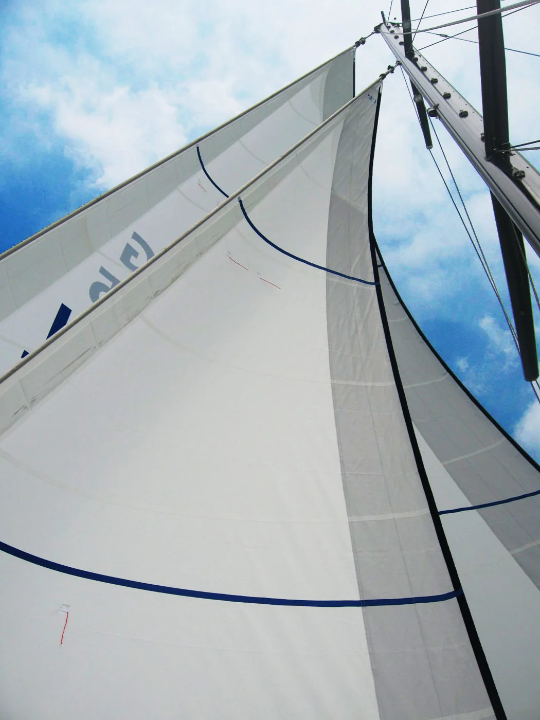 Roller furling Dacron forstaysail and genoa. Notice how the blue rolling furling cover wraps around the edge of the leech to fully protect the dacron sail.