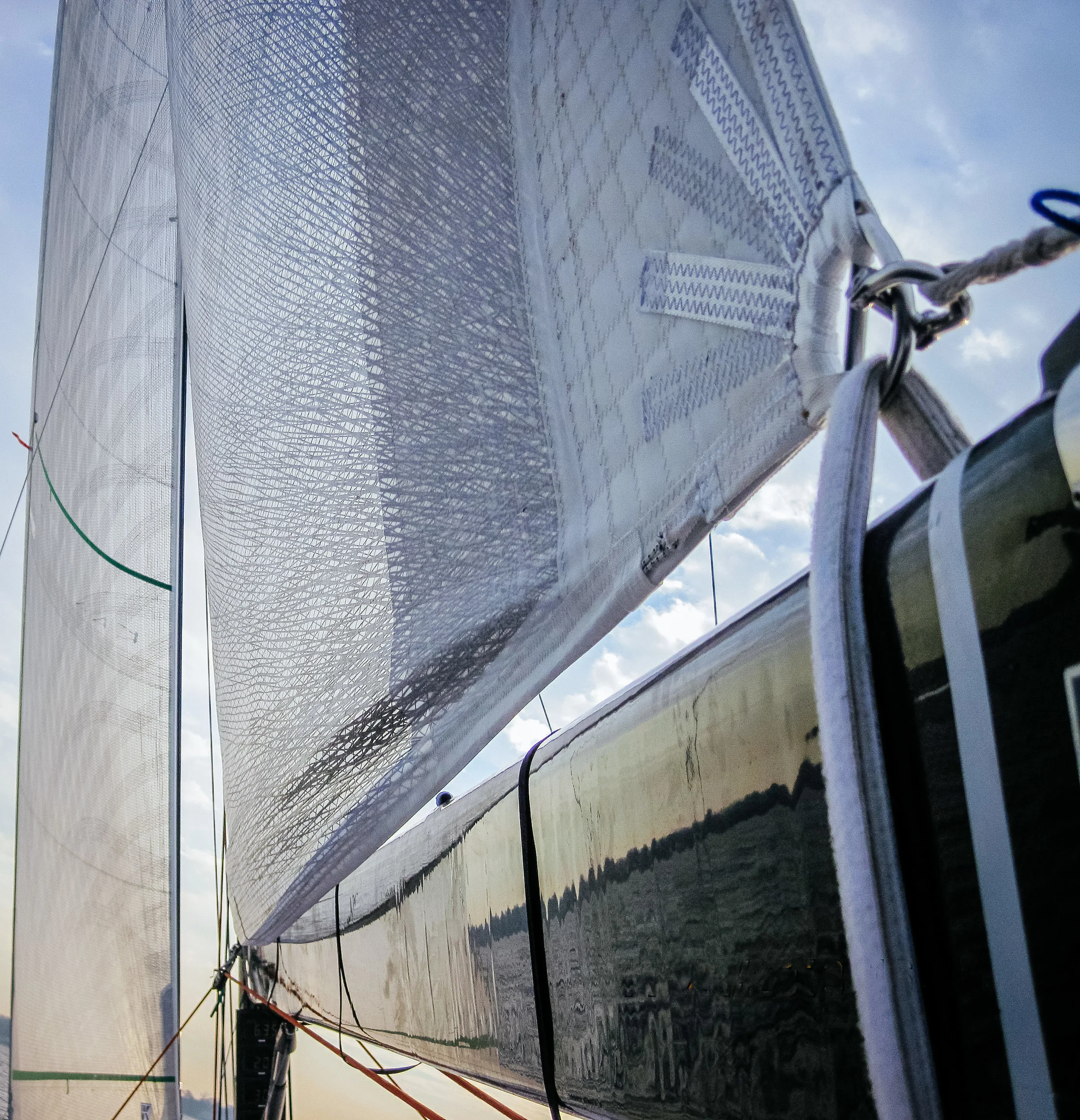 A Titanium loose-footed mainsail. A velcro strap around the boom takes the place of a clew slug or clew car.