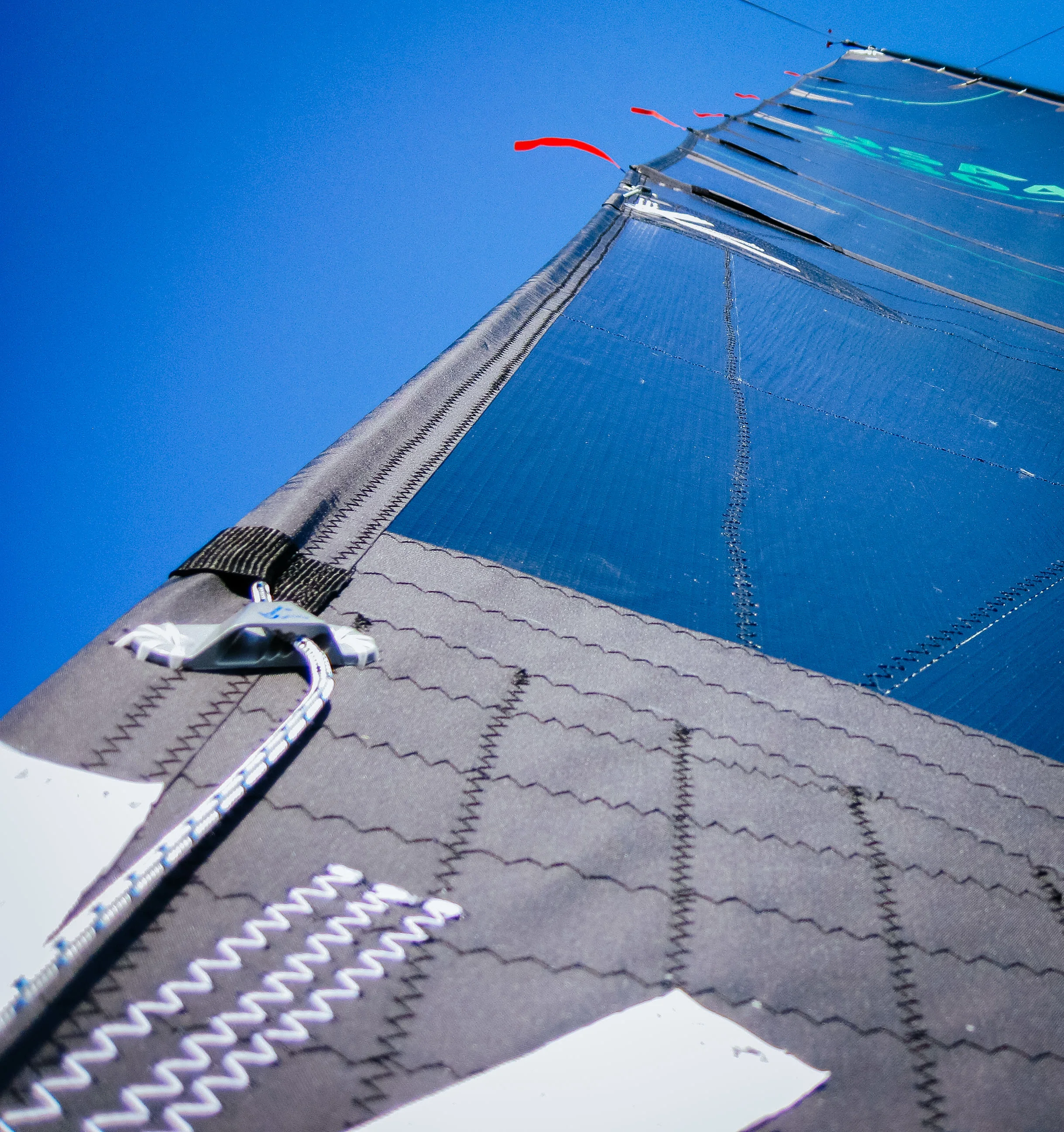 The standard location for a leech line cleat is just above the clew of a mainsail