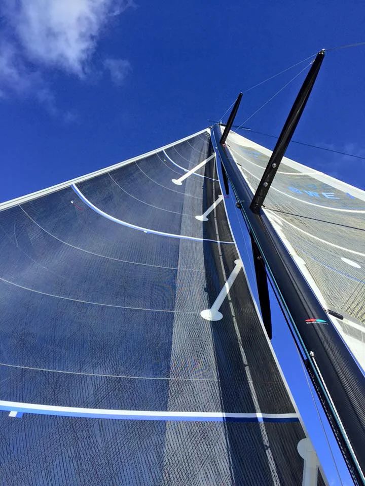 An X-Drive carbon roller-furling racing genoa on an Arcona 465. The carbon tapes are on a black aramid laminate giving the sail an all black look. 