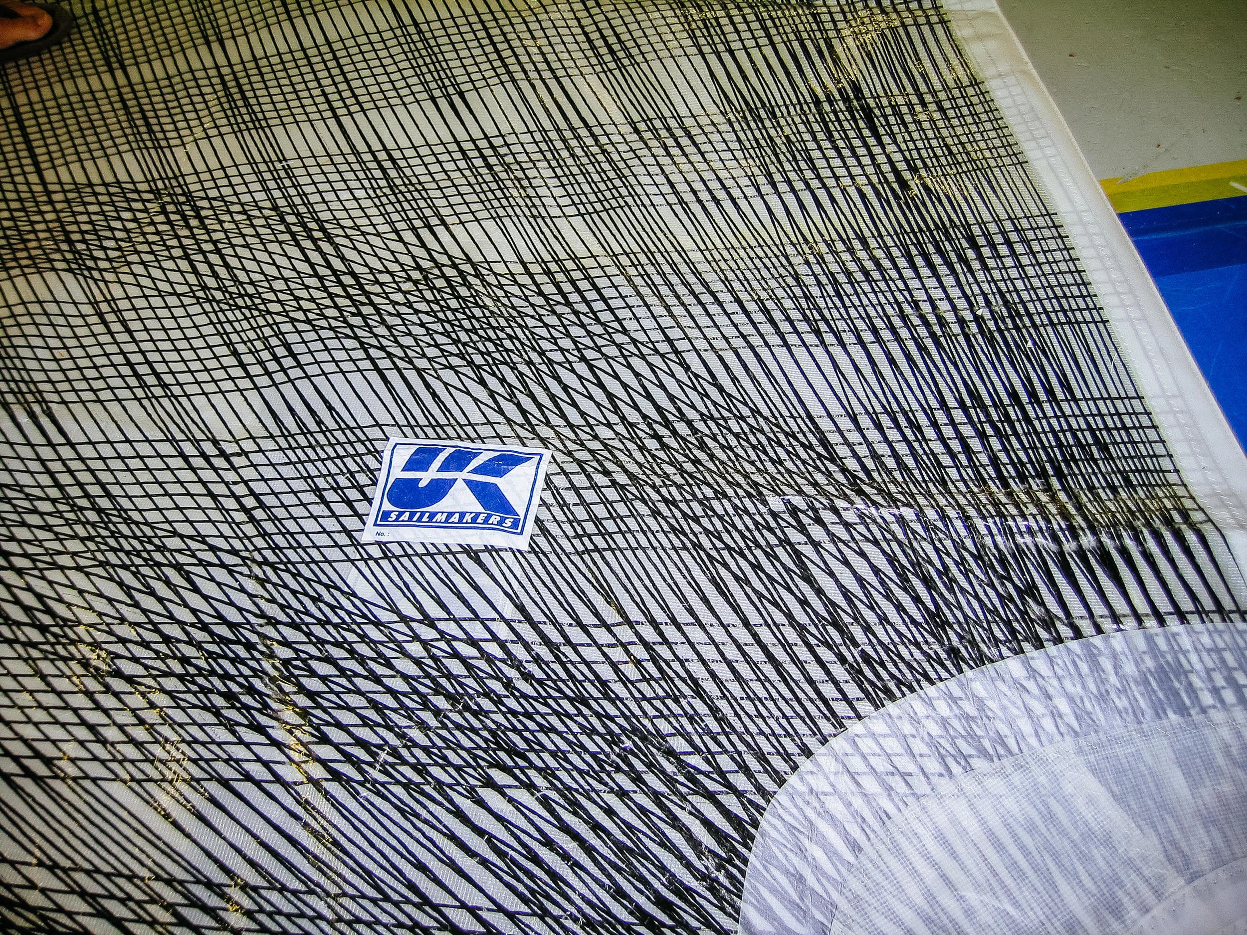Detail showing the extensive coverage of tapes are on an X-Drive sail.
