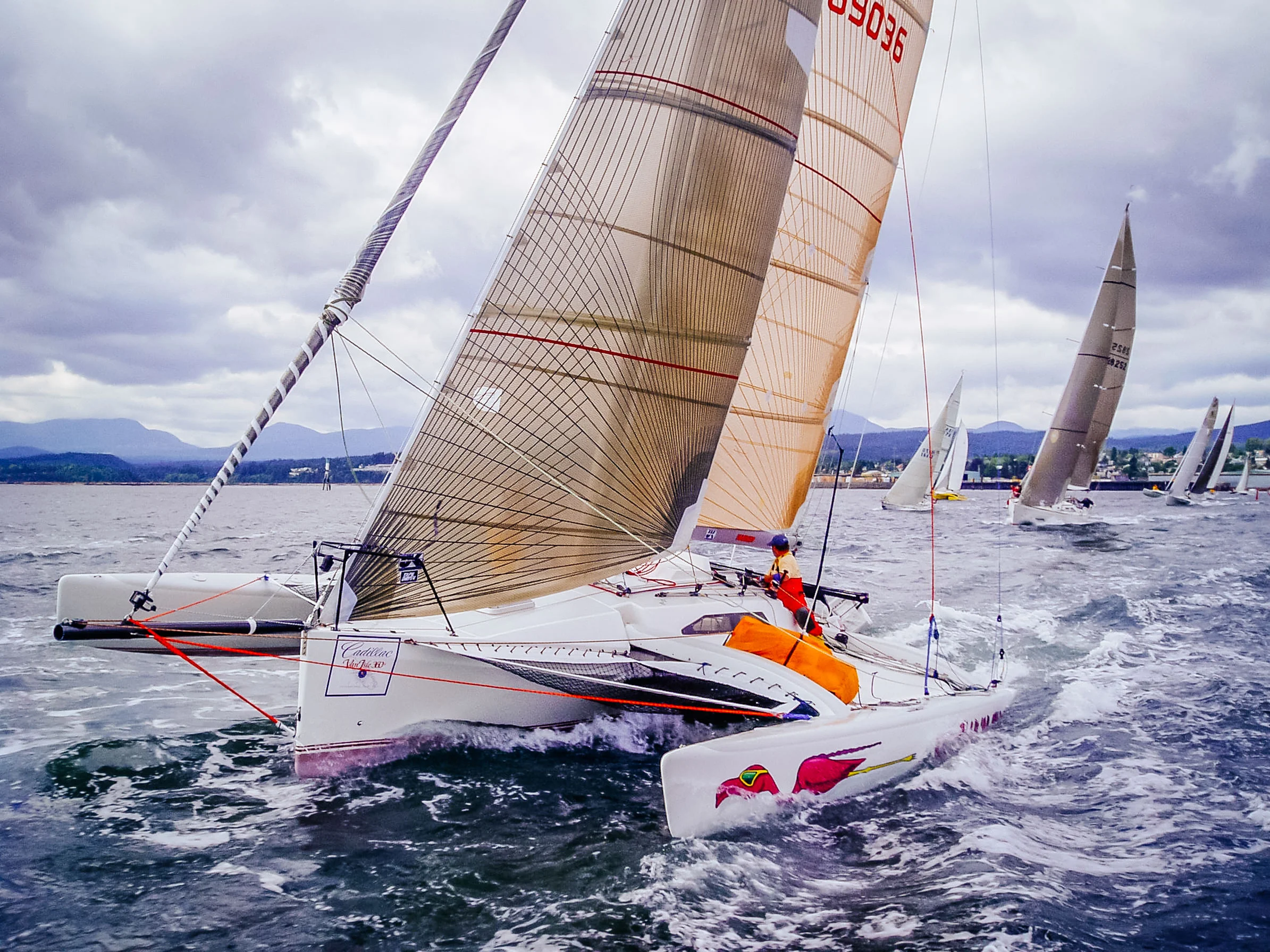 An F31 trimaran with Tape-Drive carbon genoa.