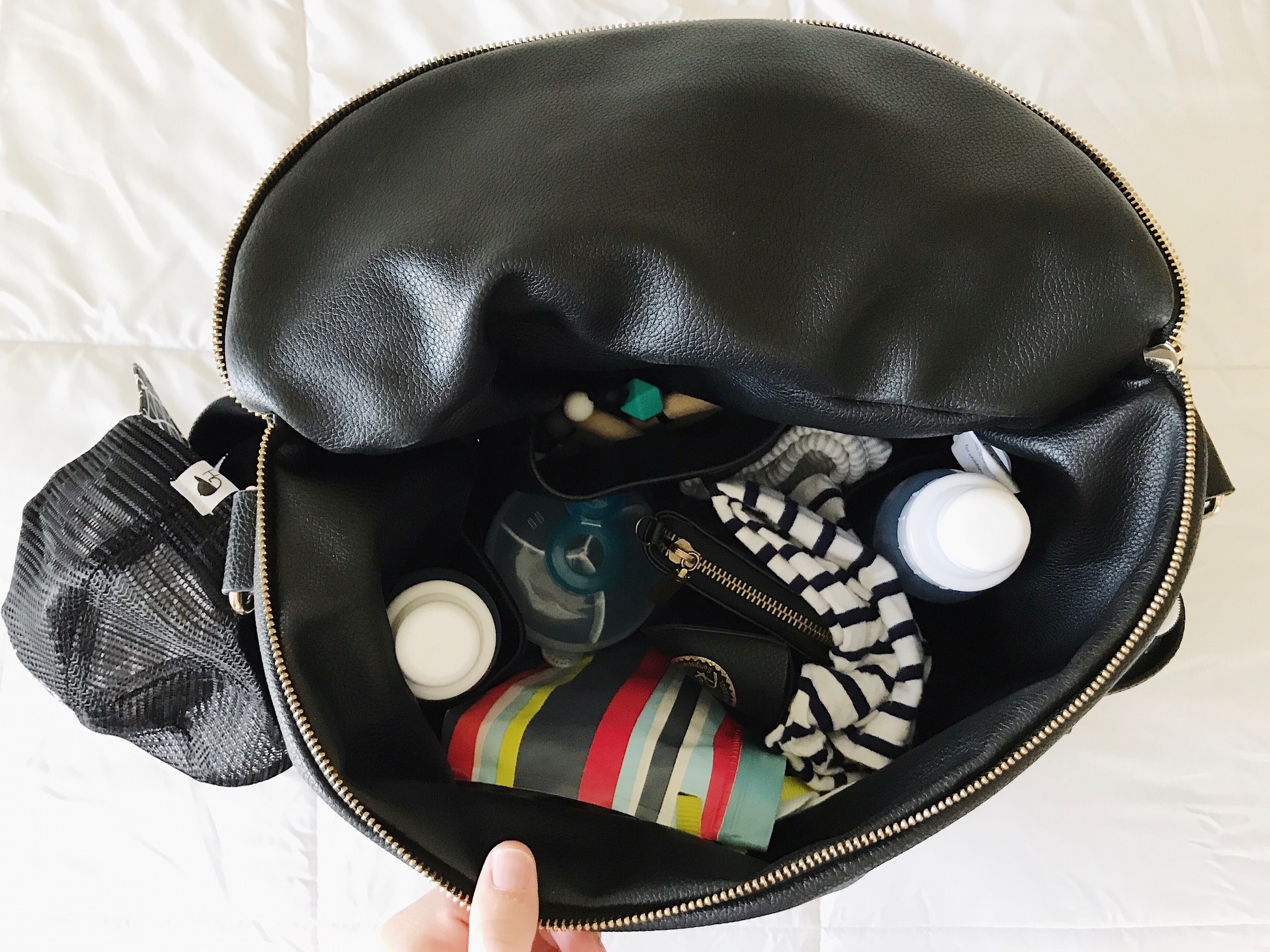 This is our daily diaper bag packed. It has 2 more inside pockets for bottles/cups and plenty of more room left to stash other things. Also has 2 outside pockets for mommas water bottle!