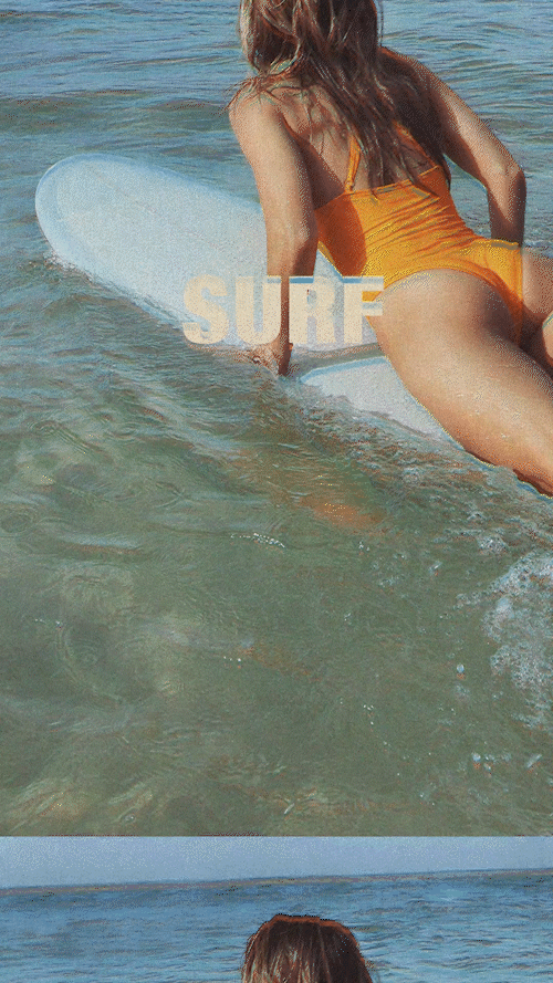 Woman in an orange swimsuit sitting on a surfboard in shallow ocean water with the word "SURF" overlaid on the image.