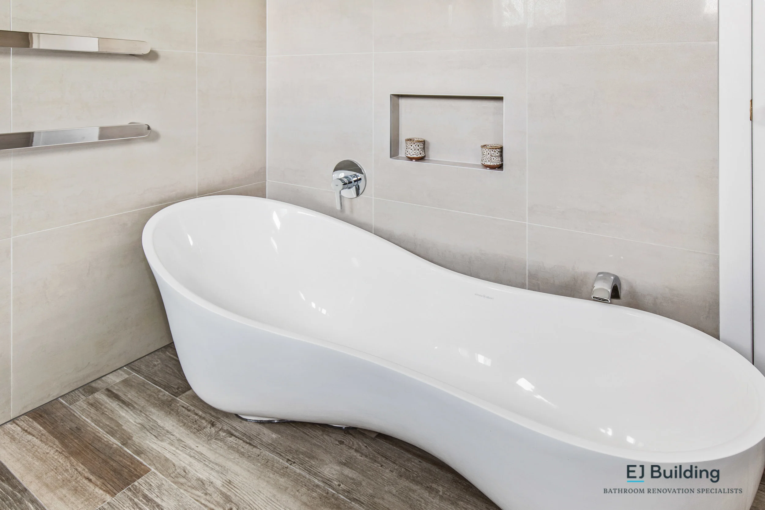 Auckland bathroom, showing timber looking tiles, freestanding bath with double wastes.