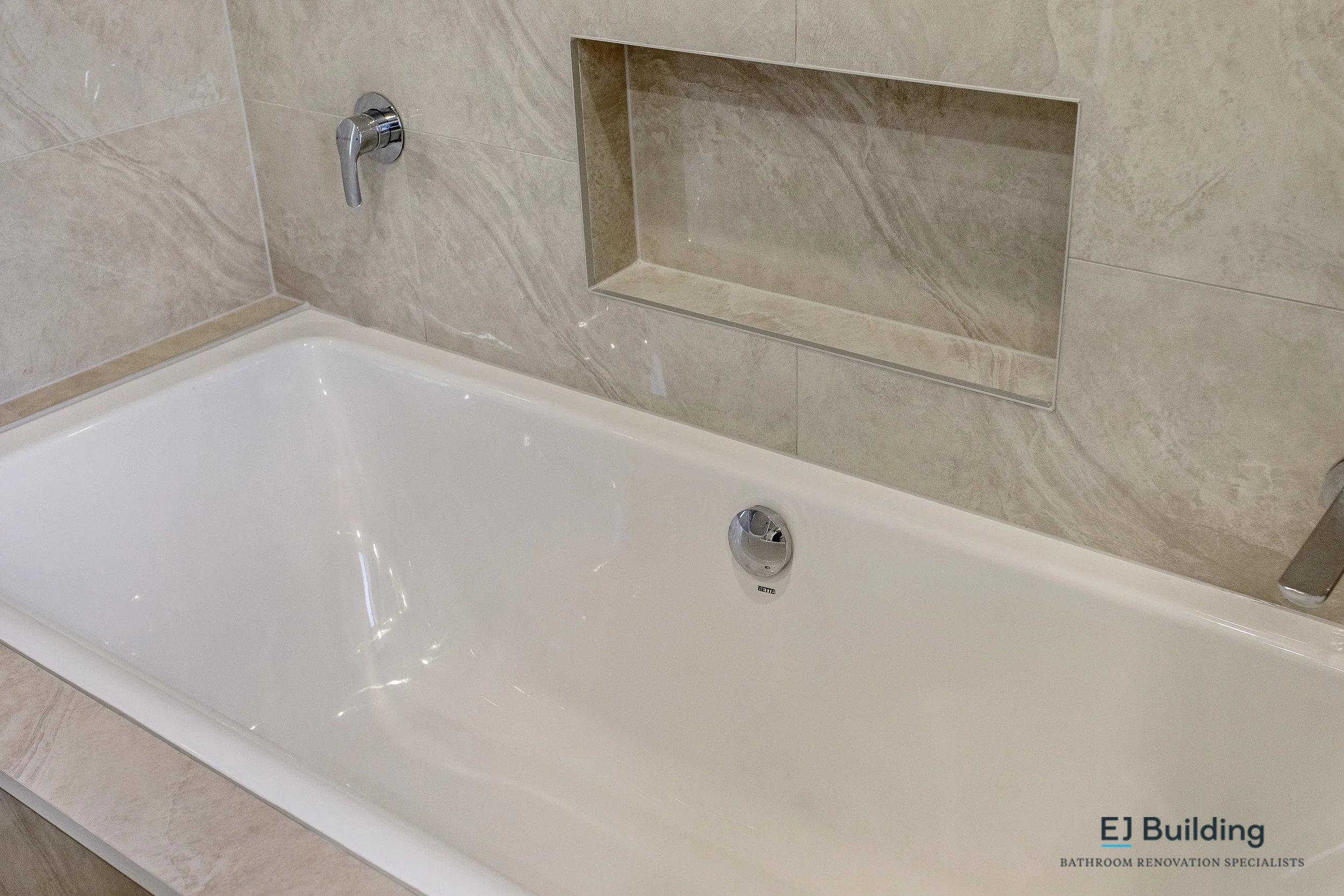 Tiled bath shelf. Ellerslie bathroom renovators.