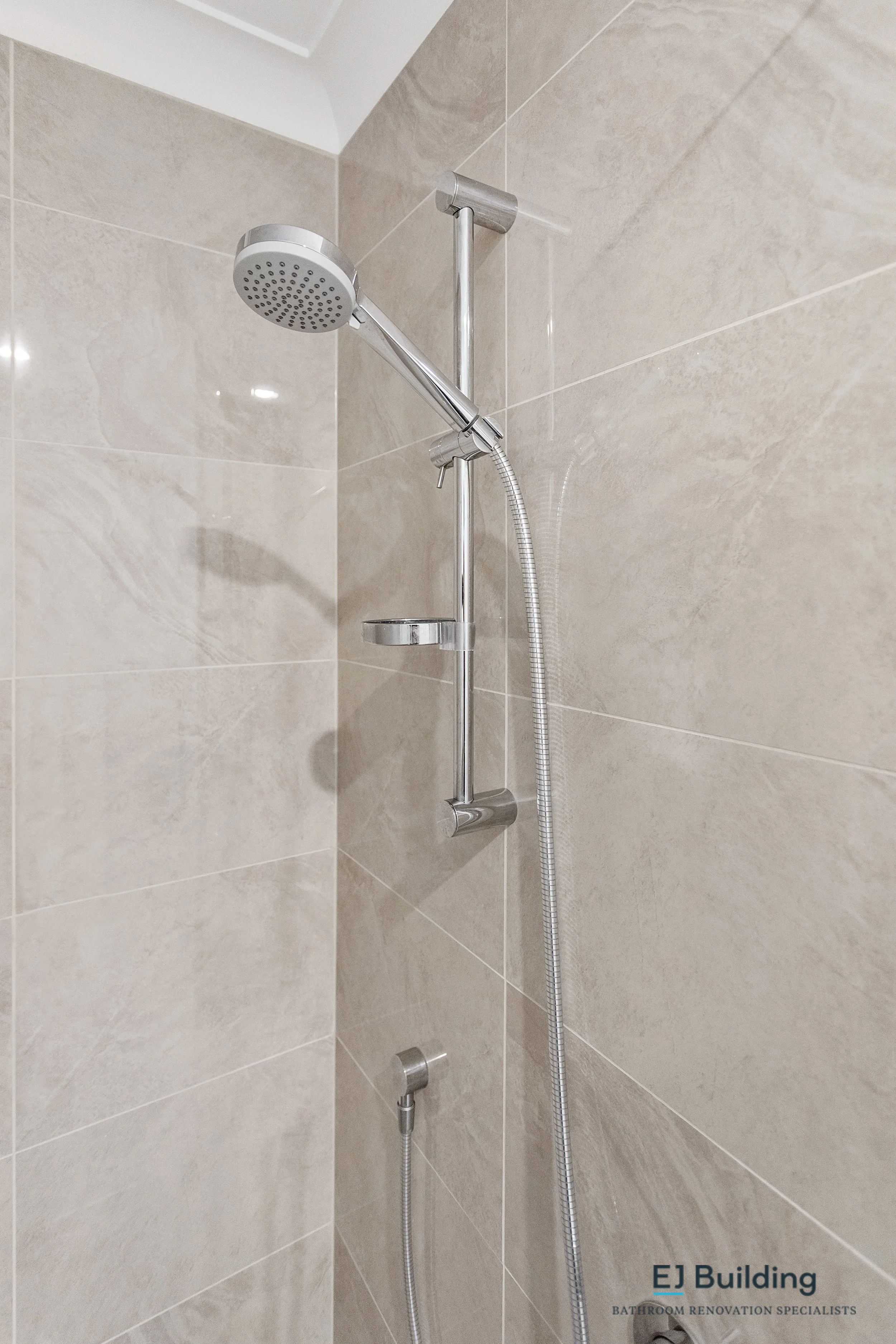 Ellerslie bathroom renovator Auckland. Tiled wet floor shower with frameless glass. Bathroomware / tapware was purchased by Mico Plumbing Lunn Ave.