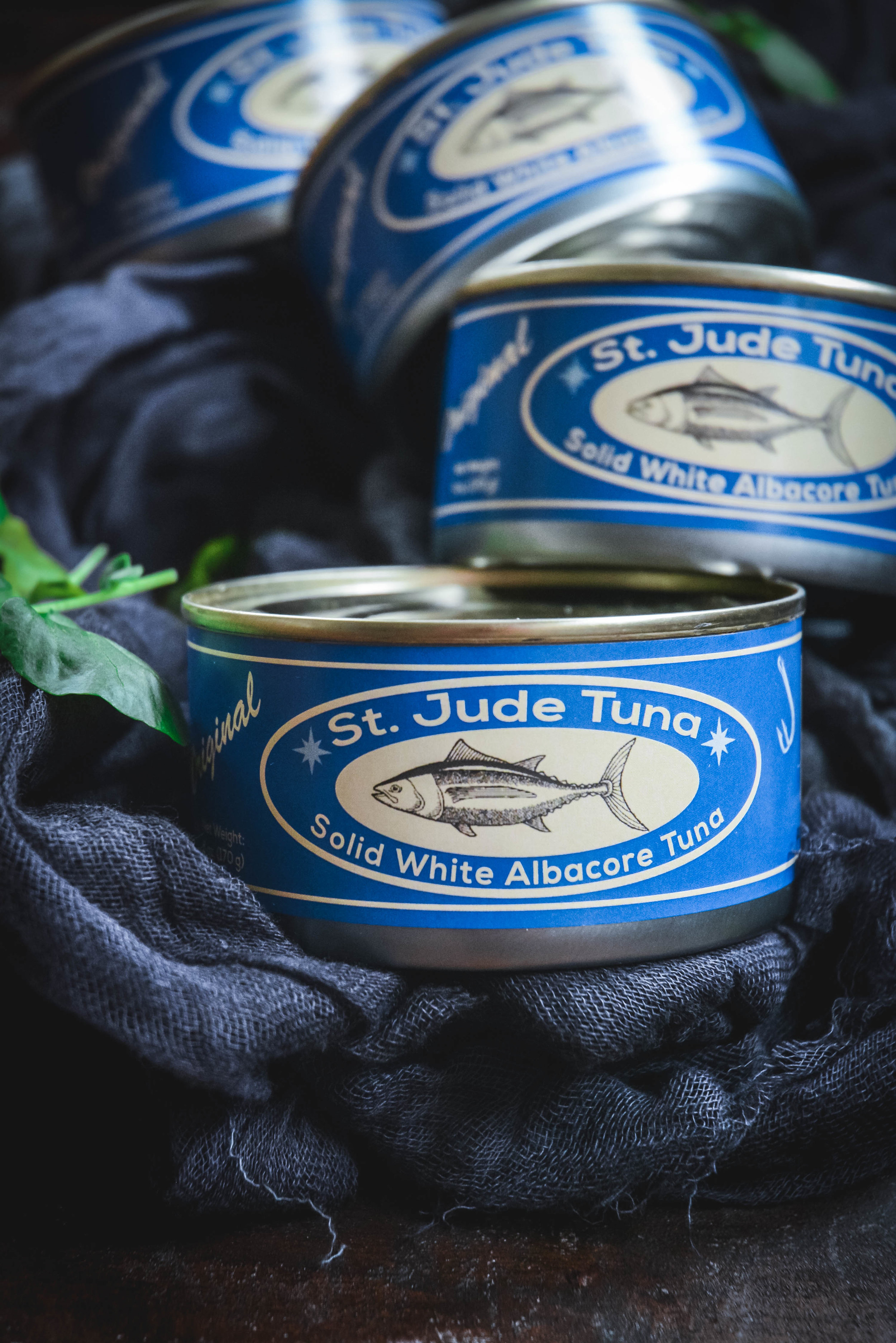 4 cans of st. jude tuna with blue labels