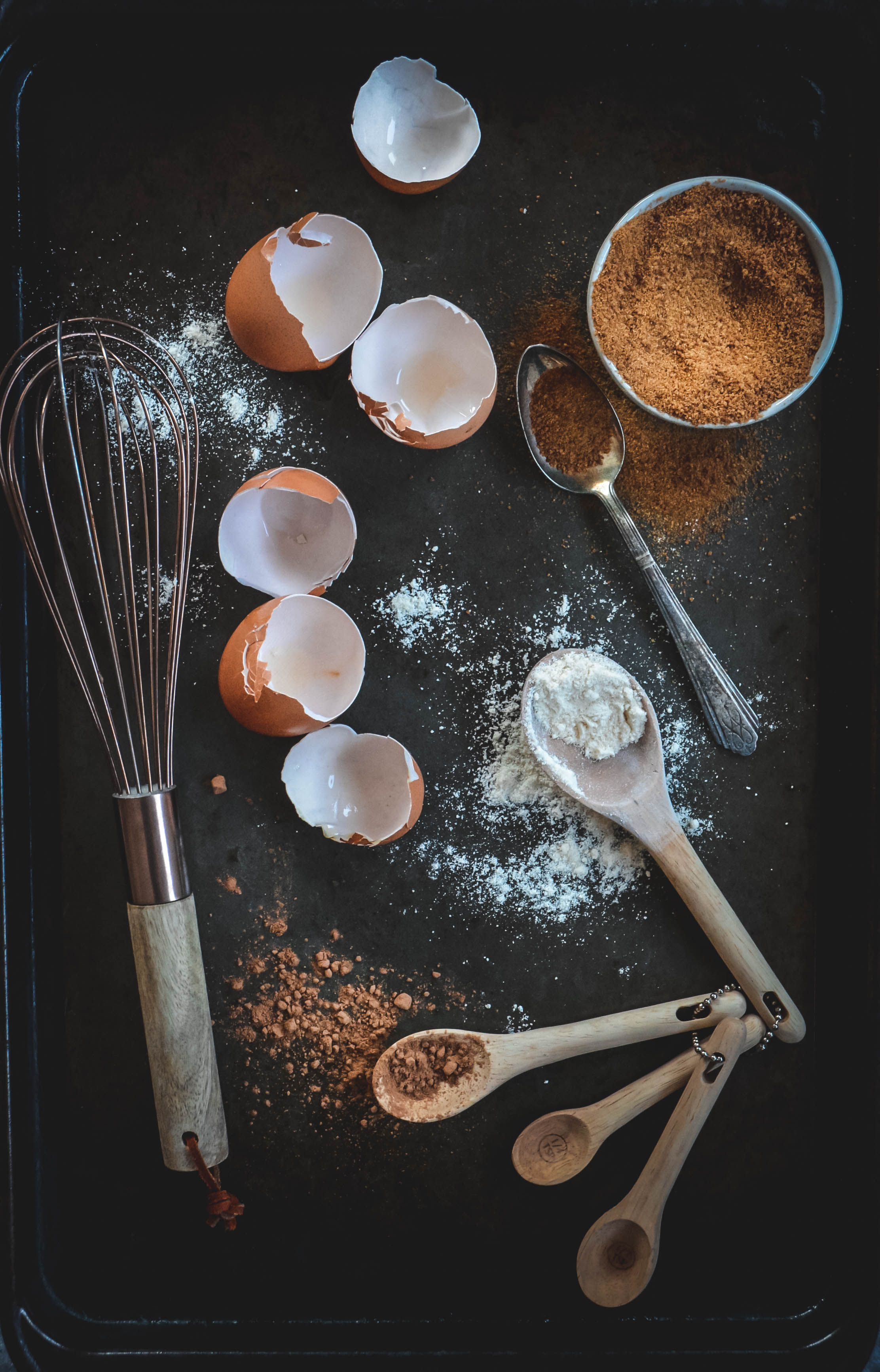 egg shells, whisk and cacao on spoons
