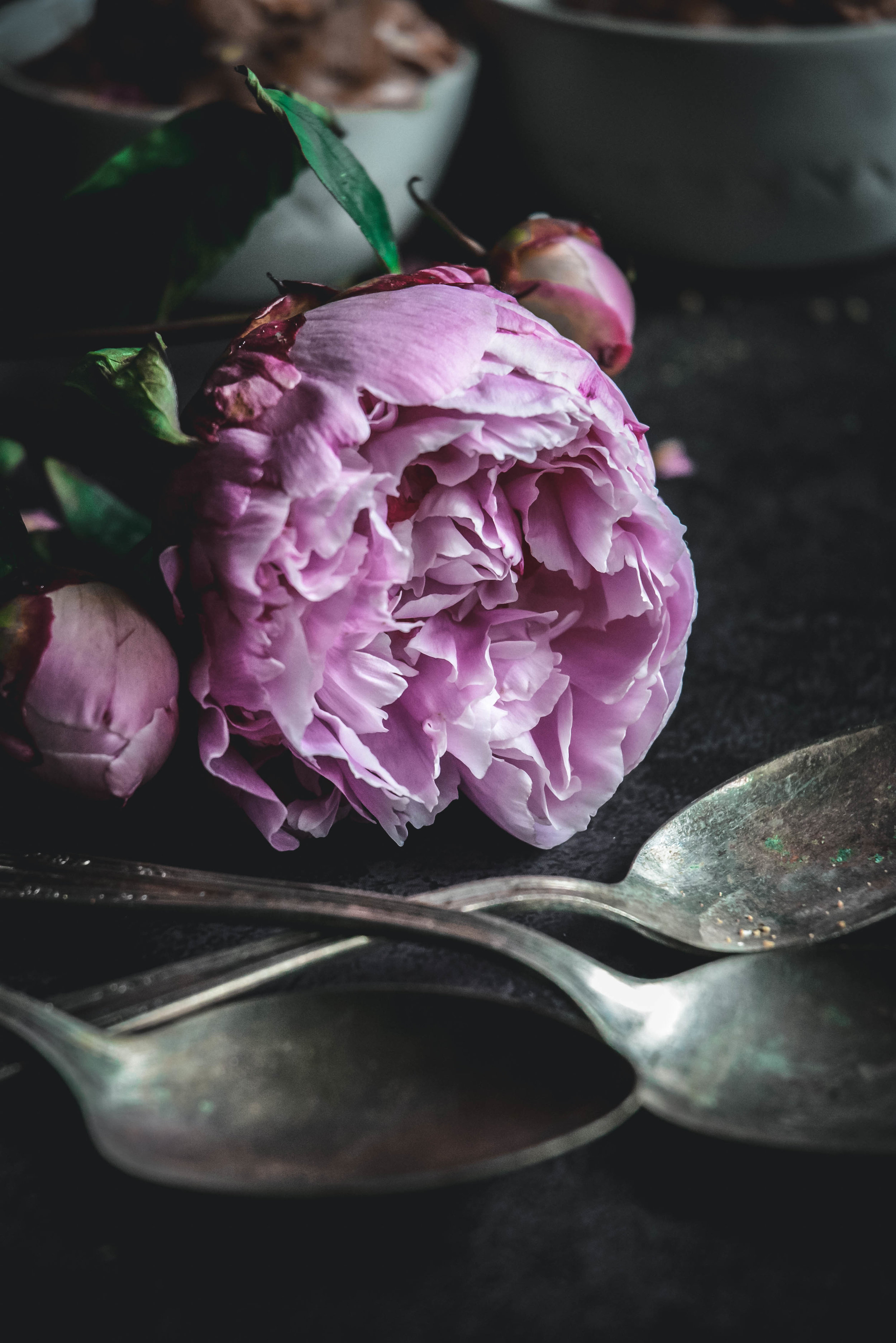peony and spoons on table