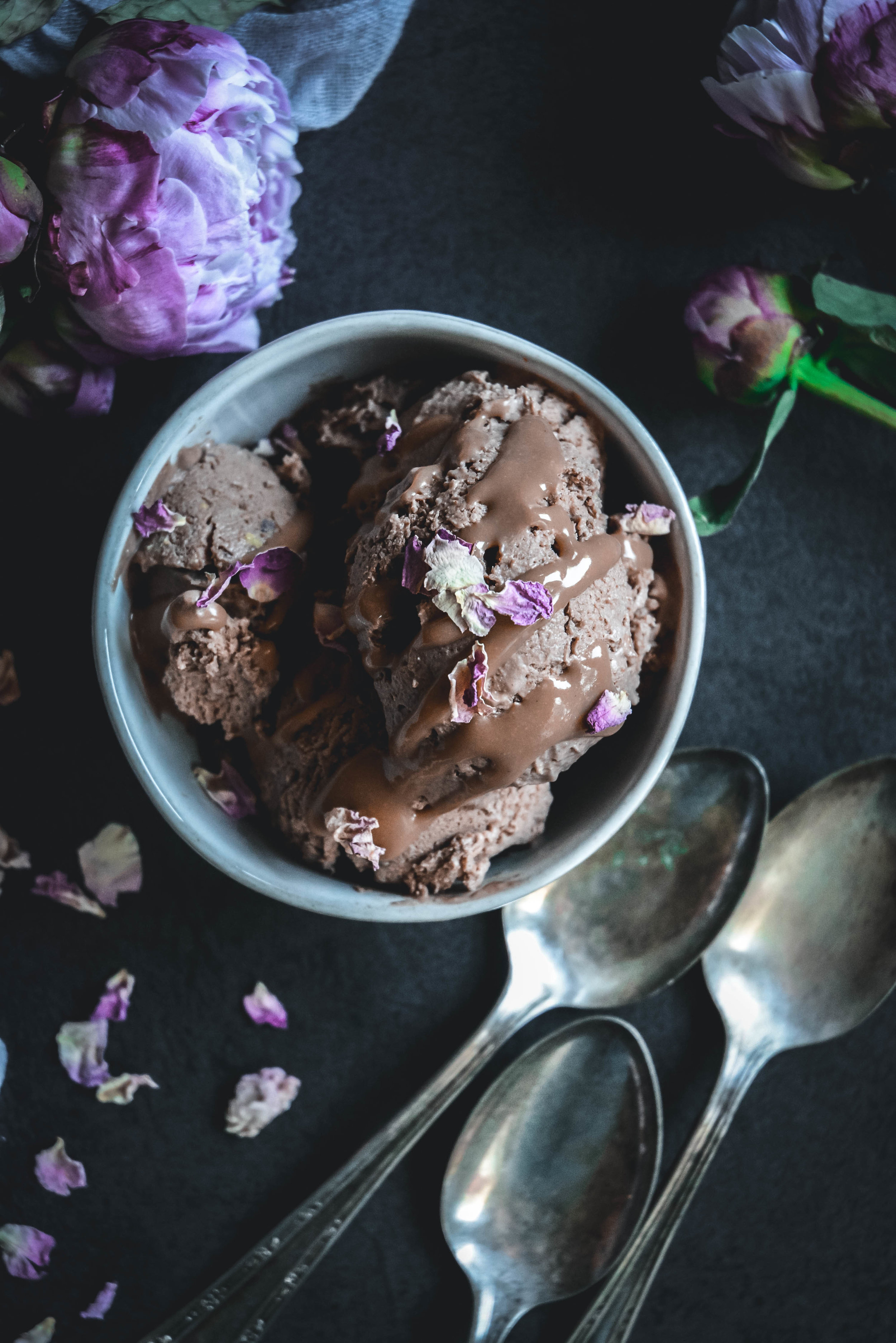 chocolate ice cream in bowl with spoons and peony's