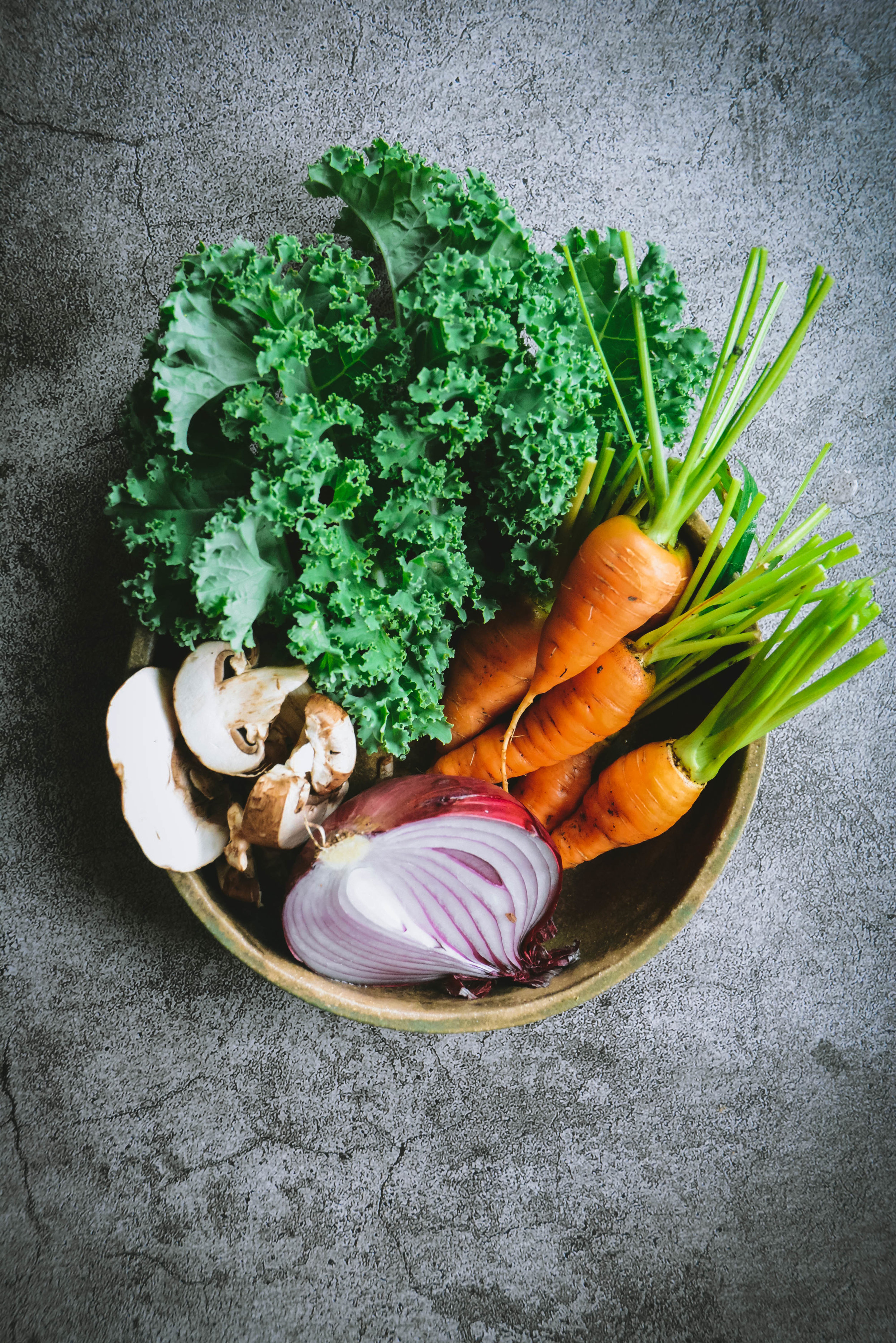 Kale mushrooms, carrots and mushrooms in bowl on table