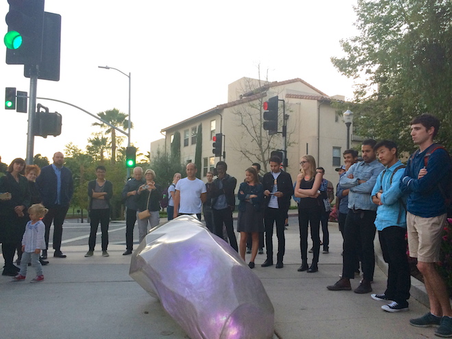  A group of perplexed onlookers view the glowing asteroid. 