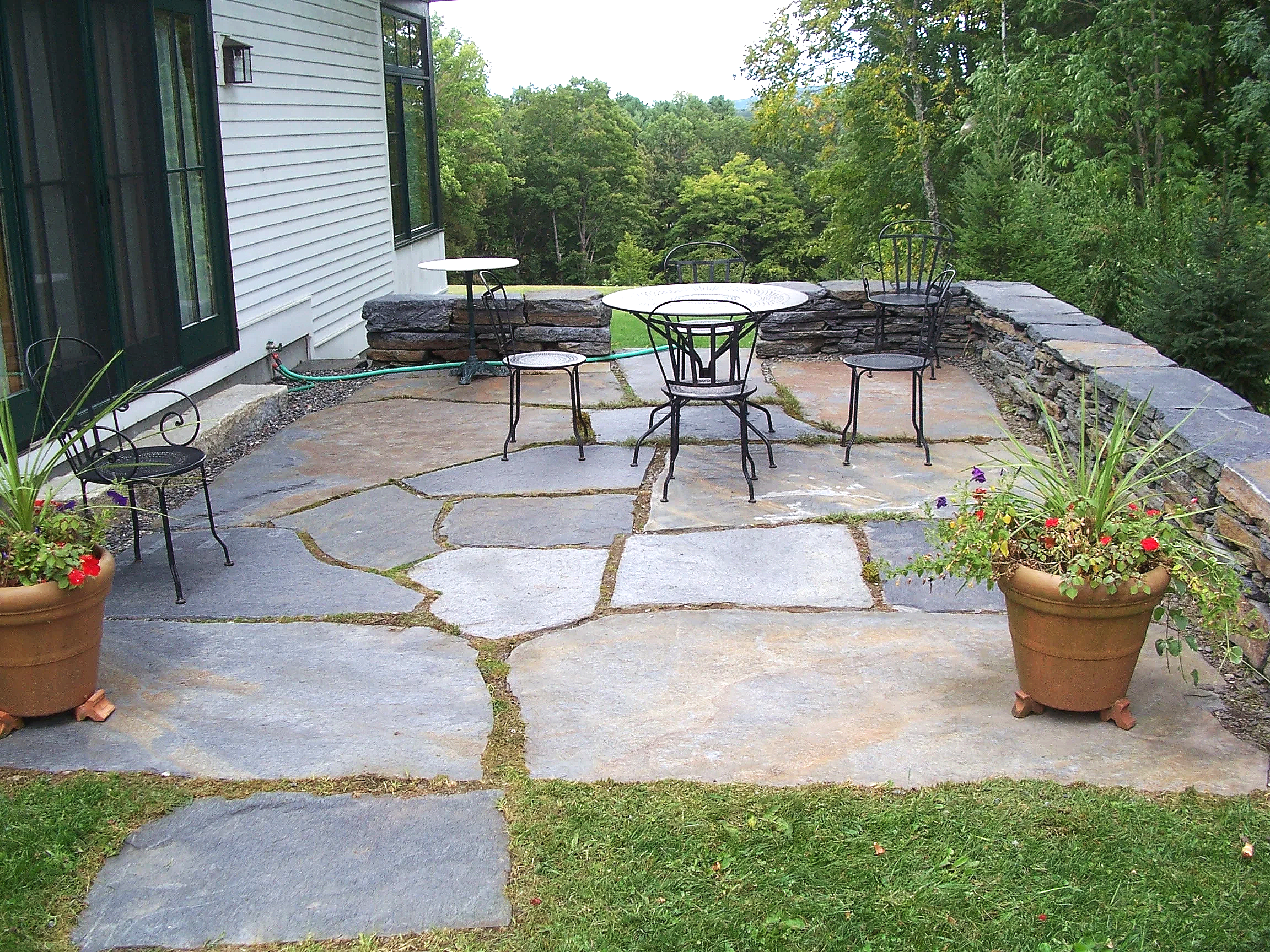 Stone patio and dry stone seating wall