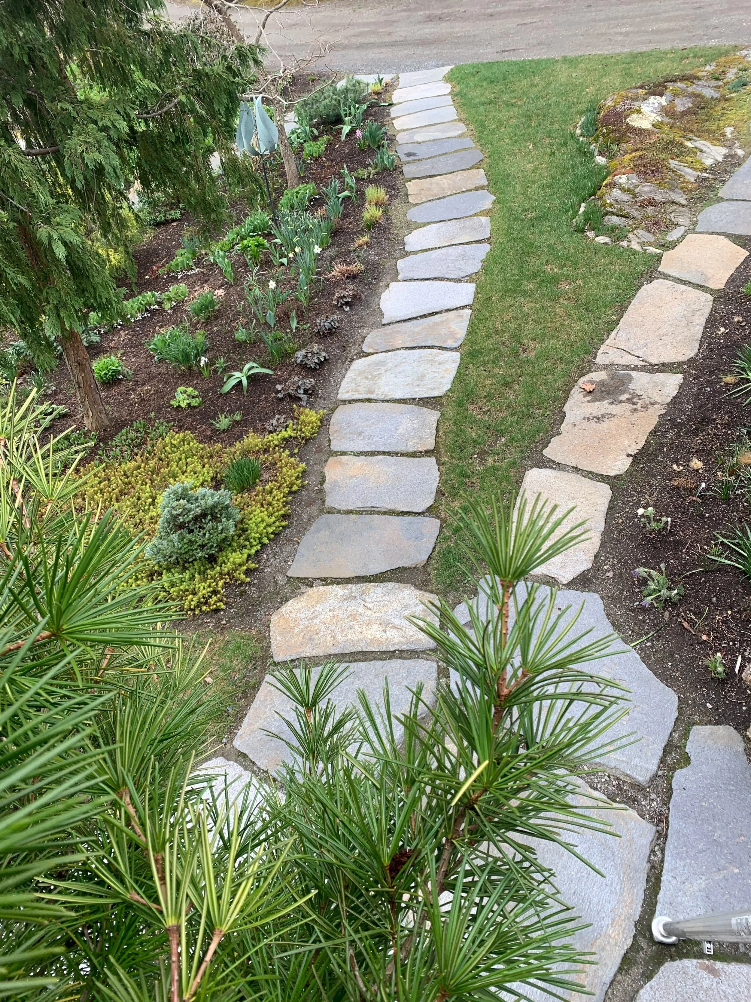 Two stone entry walkways with perennial gardens