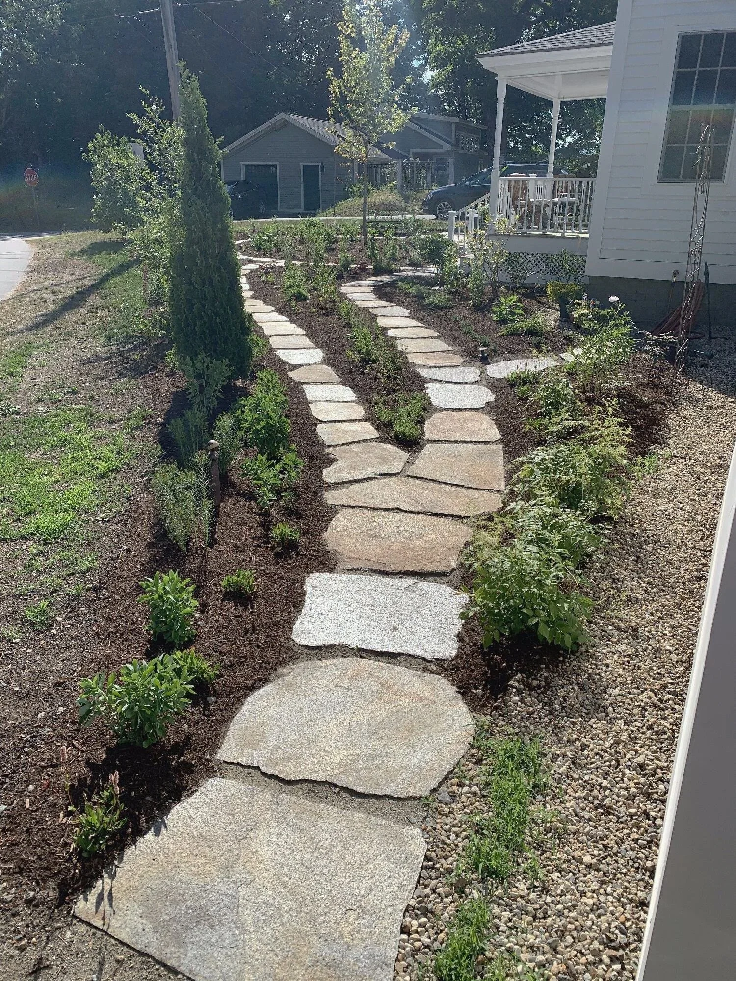 Converging garden paths with all season perennial gardens