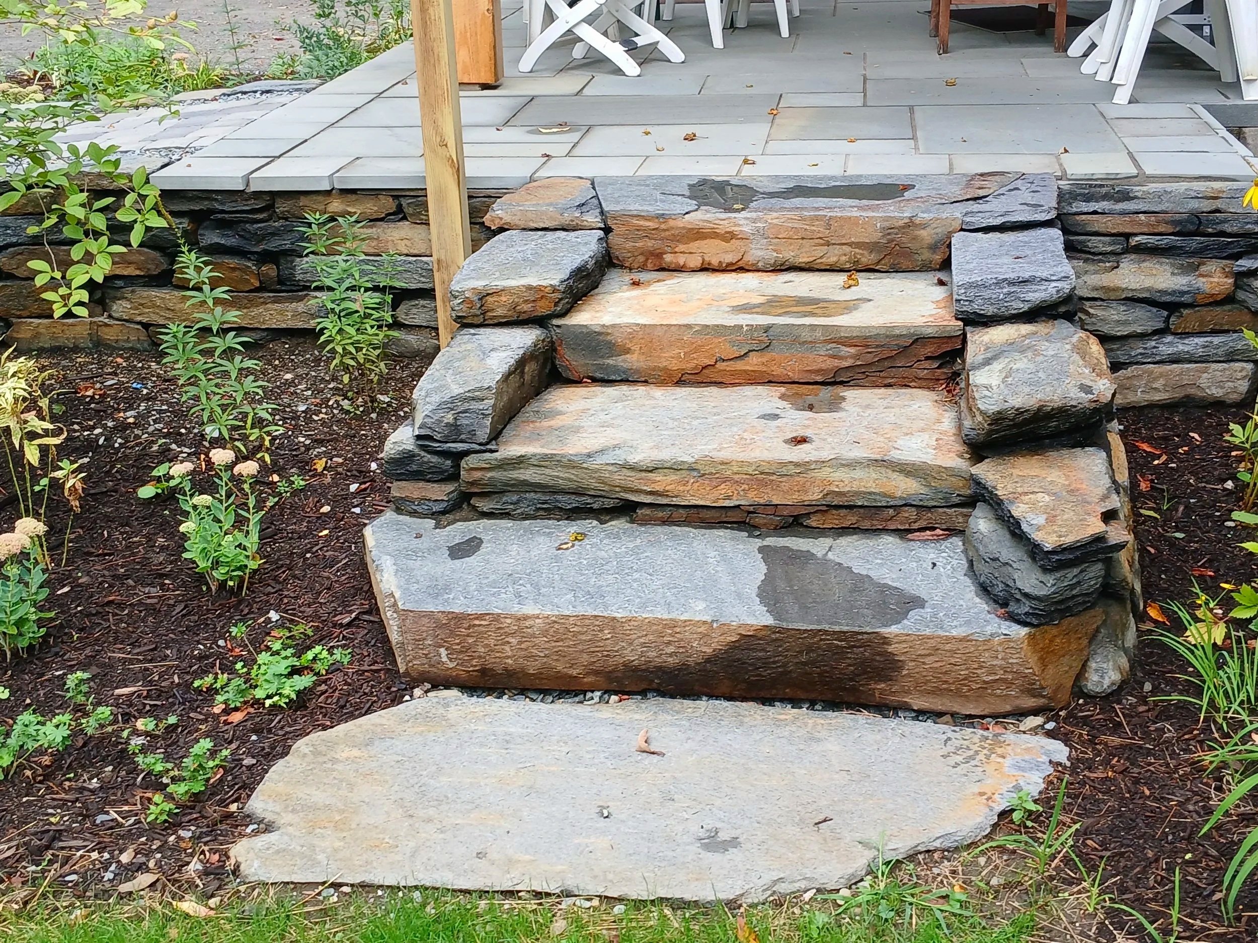 Natural stone steps to blue stone entrance patio