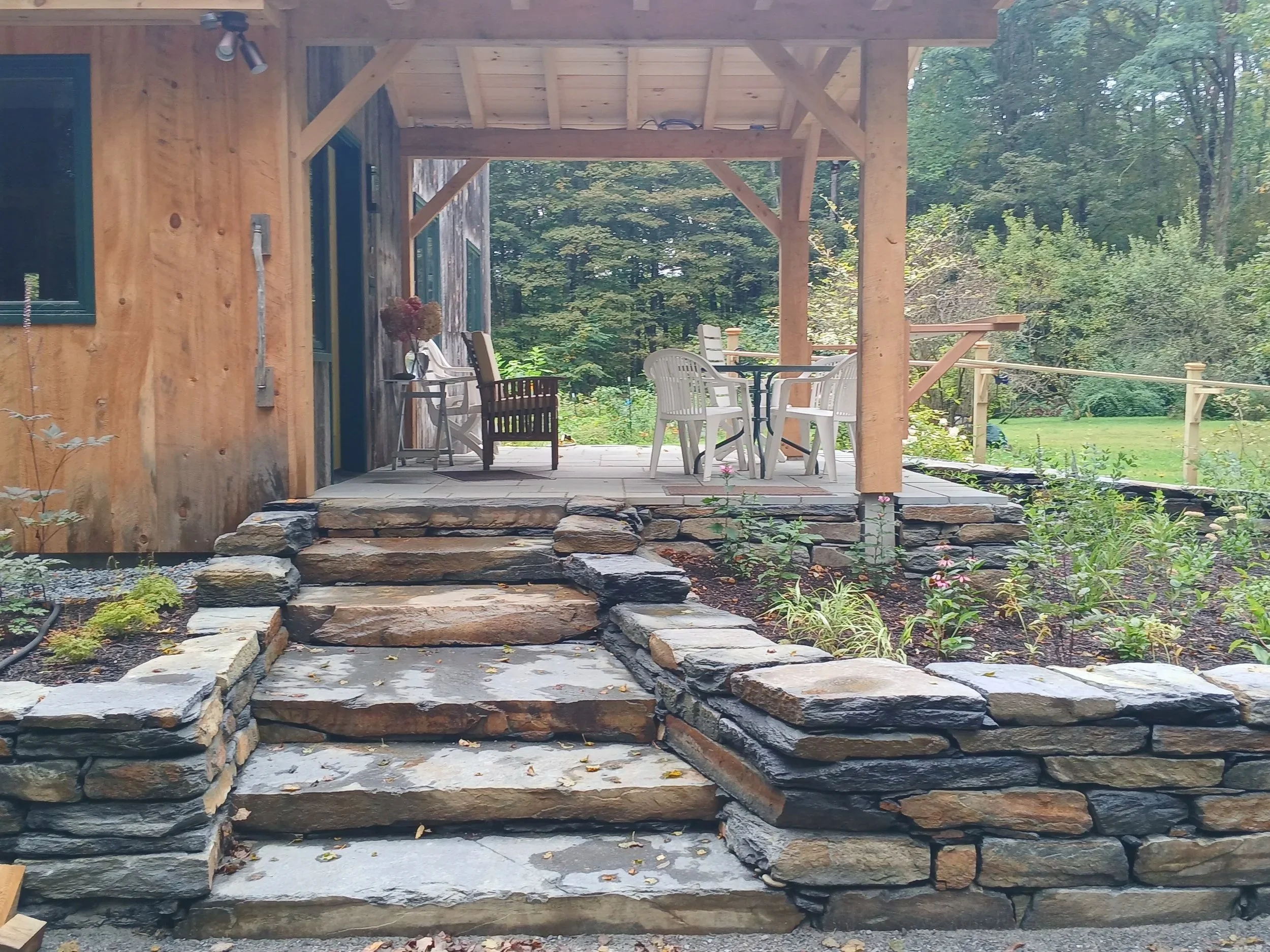 Integrated stone steps and wrapping stone walls