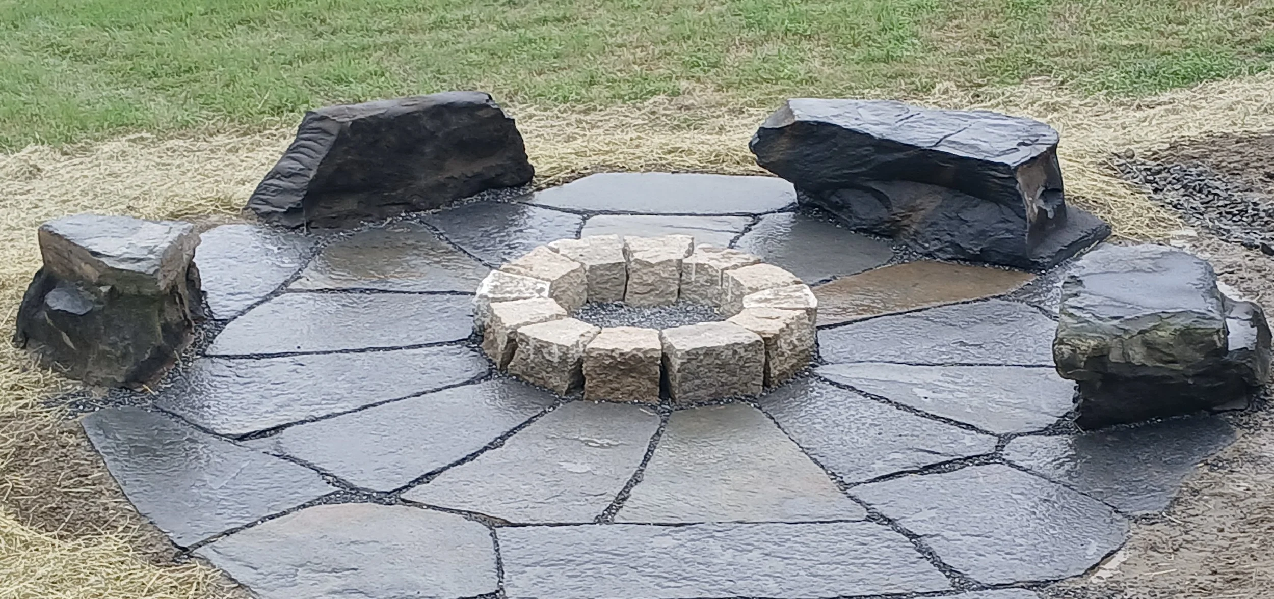 Hand split granite fire pit surrounded by stone benches