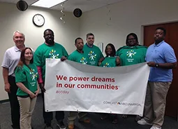 John Klein and Andrew Selby of Joseph's House with Comcast Staff