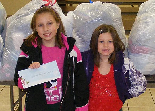 Abigail and her sister bring donations to Joseph's House