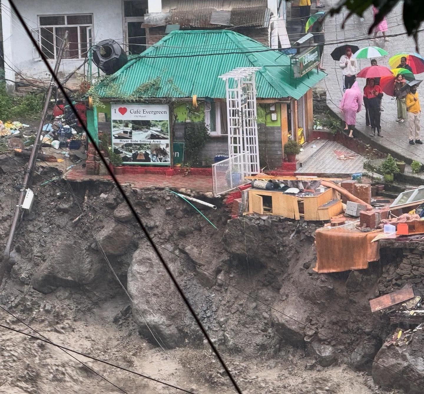 Old Manali: The dining area where we grabbed some dinner last night in the Evergreen Cafe with the green roof is gone. Back in July, we witnessed to Manu, the owner of the destroyed coffee shop next door and to the right. I believe we gave him a Bibl